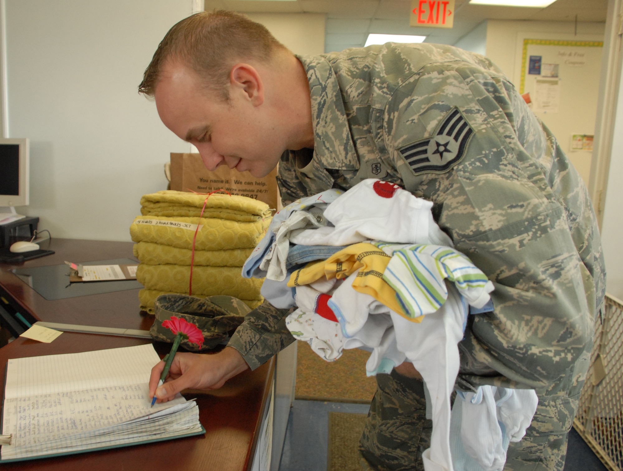 Staff Sgt. Benjamin Lifto, 436th Maintenance Squadron, signs in and brings children's clothes and items to donate to the Airman's Attic. The Airman's Attic is a volunteer-run base organization that offers Dover Airmen and their families new and used donated items. (U.S Air Force photo/Airman 1st Class Shen-Chia Chu)