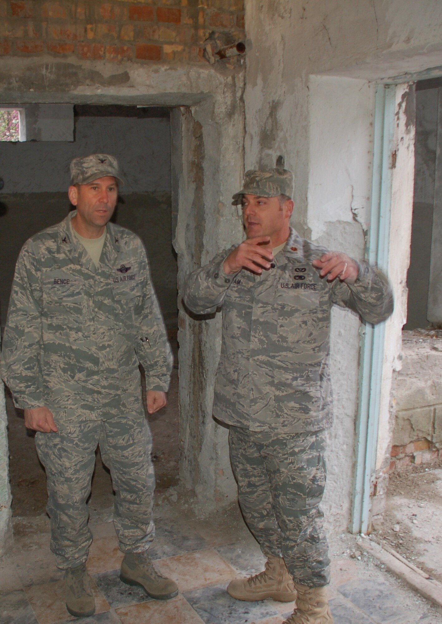 Maj. Johnnie Adam, an architect deployed from the Kansas Air National Guard, shows Col. Christopher Bence, 376th Air Expeditionary Wing commander, the current progress at Birdik Village School following the ground-breaking ceremony at the Kyrgyz Republic school, April 14. In a partnership with US Central Command, the State Department and Manas Air Base, Major Adam is overseeing a $470,000 project to renovate the 200-student school during his deployment to nearby Manas Air Base. Nearly 200 villagers, construction workers and distinguished guests attended the ceremony to kick off the six-month project. (U.S. Air Force photo/Tech. Sgt. Phyllis Hanson) 