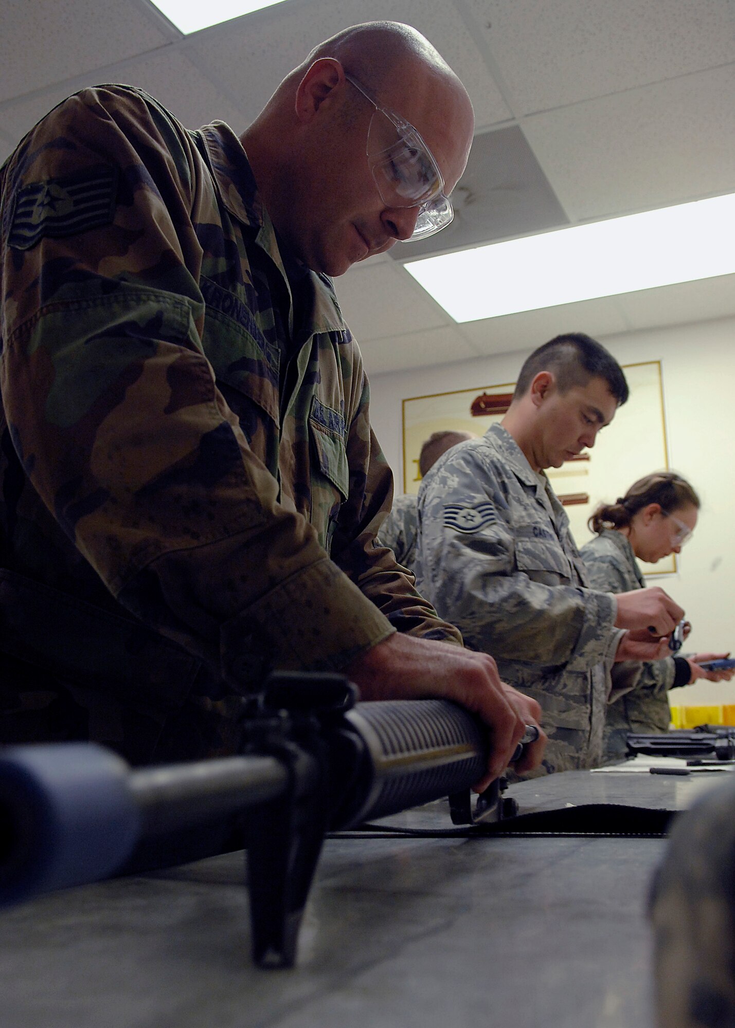 Tech. Sgt. Jason Kronenberg cleans his weapon during Expeditionary Combat Skills Training on Charleston AFB April 8. ECST is required for Airmen who are deploying to hostile areas where combat knowledge and skills are required. Sergeant Kronenberg is with the 437th Maintenance Group. (U.S. Air Force photo/Senior airman Katie Gieratz)
