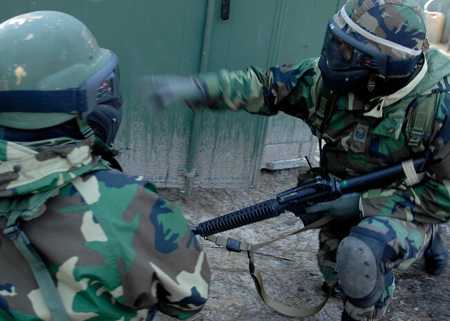 Master Sgt. Joe Garza instructs a fellow Team Charleston member what do to during an attack while participating in the Expeditionary Combat Skills Training exercise on Charleston AFB April 8. ECST is required for Airmen who are deploying to hostile areas where combat knowledge and skills are required. On average there are 40 students in the classes. Sergeant Garza is with the 437th Logistics Readiness Squadron.(U.S. Air Force photo/Senior Airman Katie Gieratz)
