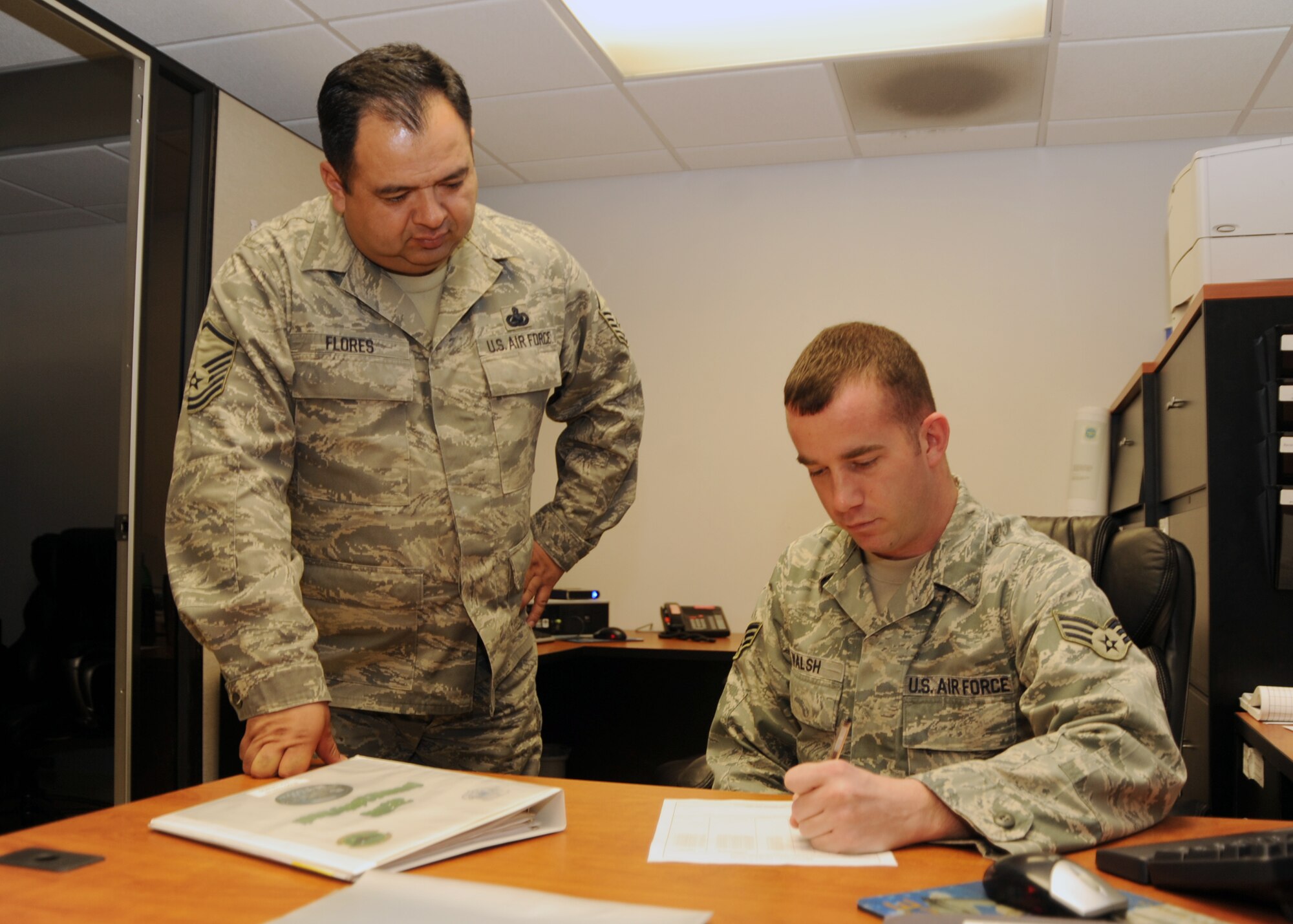 SCOTT AIR FORCE BASE, Ill. --Master Sgt. Danny Flores reviews workplace safety items with Senior Airman Brendan Walsh.  Both are with the 375th Logistics Readiness Squadron. (U.S. Air Force photo/Airman 1st Class Wesley Farnsworth)
