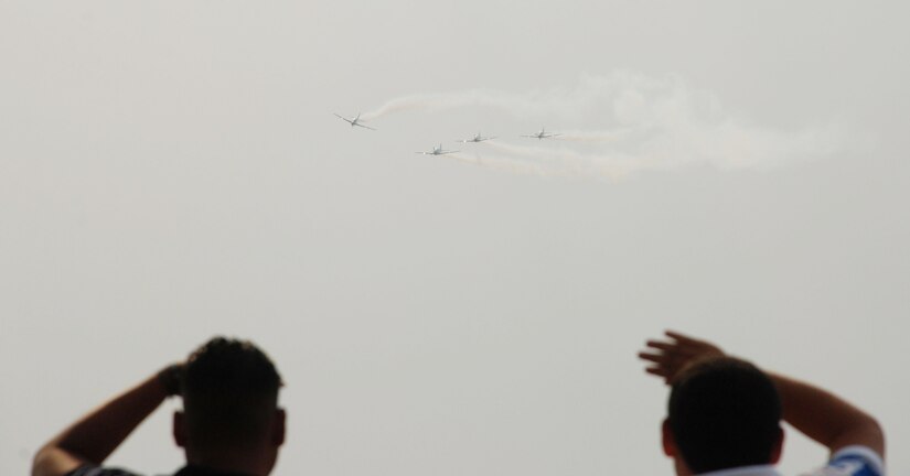SOTO CANO AIR BASE, Honduras - A team from the Brazilian Air Force Air Demonstration Squadron performs a nearly one-hour demonstration at Tegucigalpa Airport April 14.  Also known as Smoke Squadron, the Brazilian team flies the Embraer EMB 312 Tucano and has been on display since May 1952.  Airmen and Soldiers from Joint Task Force-Bravo here were on hand to support the show.  (U.S.. Air Force photo/Tech. Sgt. Rebecca Danét)