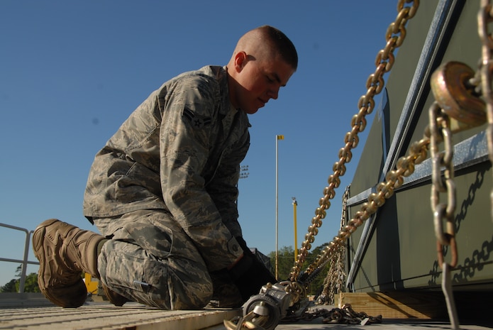 Airman 1st Class Nicholas Braun works on securing boxes of airfield matting to a pallet at the 437th Aerial Port Squadron here April 9. Charleston AFB is scheduled to palletize and load approximately 32 acres of matting to be airlifted to locations throughout the Middle East. Airman Braun is an air transportation apprentice with 437 APS. (U.S. Air Force photo/Airman Ian Hoachlander)