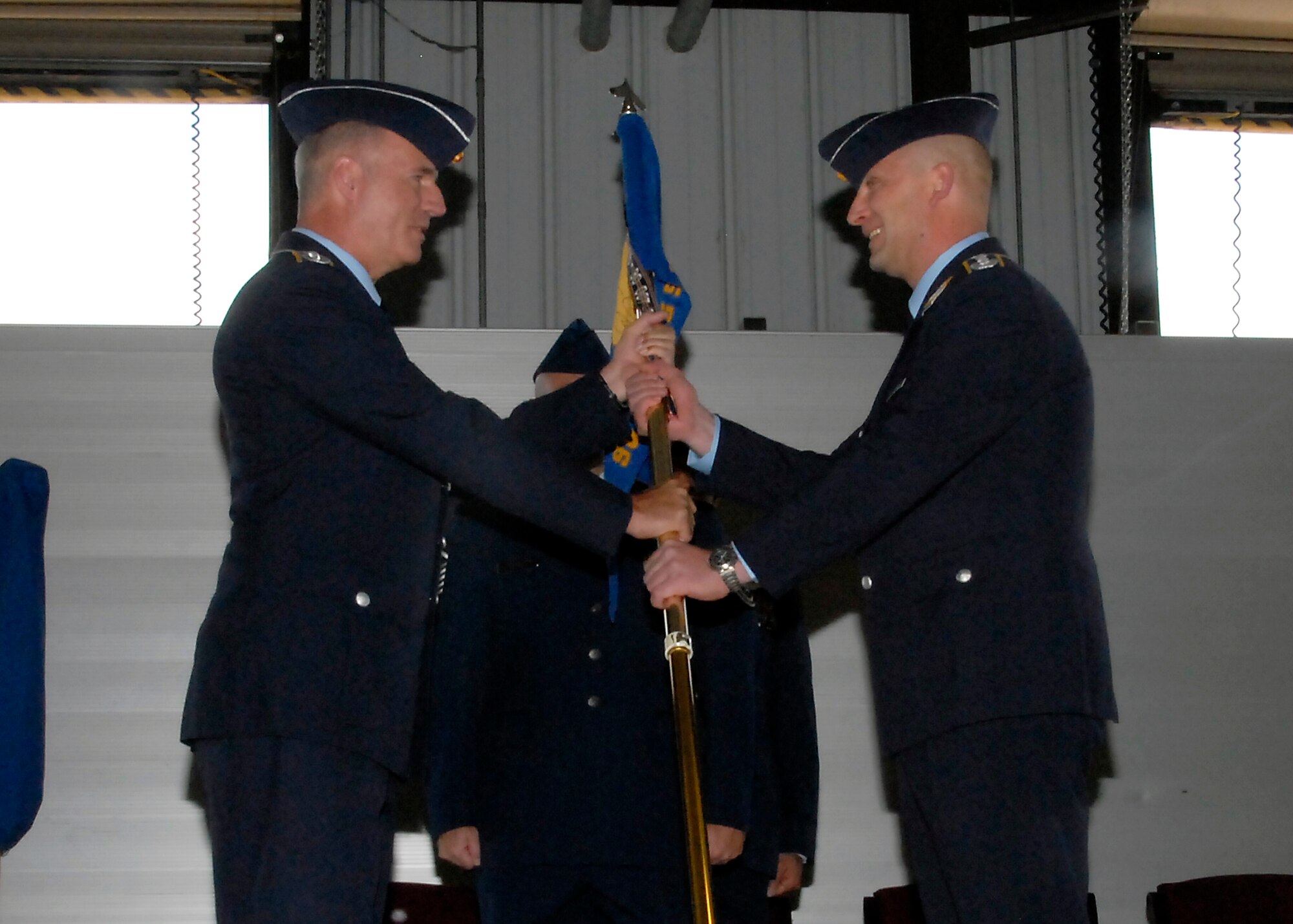 German air force Lt. Col. Oliver Habel, incoming commander of the 90th Flying Training Squadron, receives the squadron guidon from German air force Col. Axel Pohlmann, 80th Operations Group commander, during a change of command ceremony April 10. (U.S. Air Force photo/Mike Litteken)