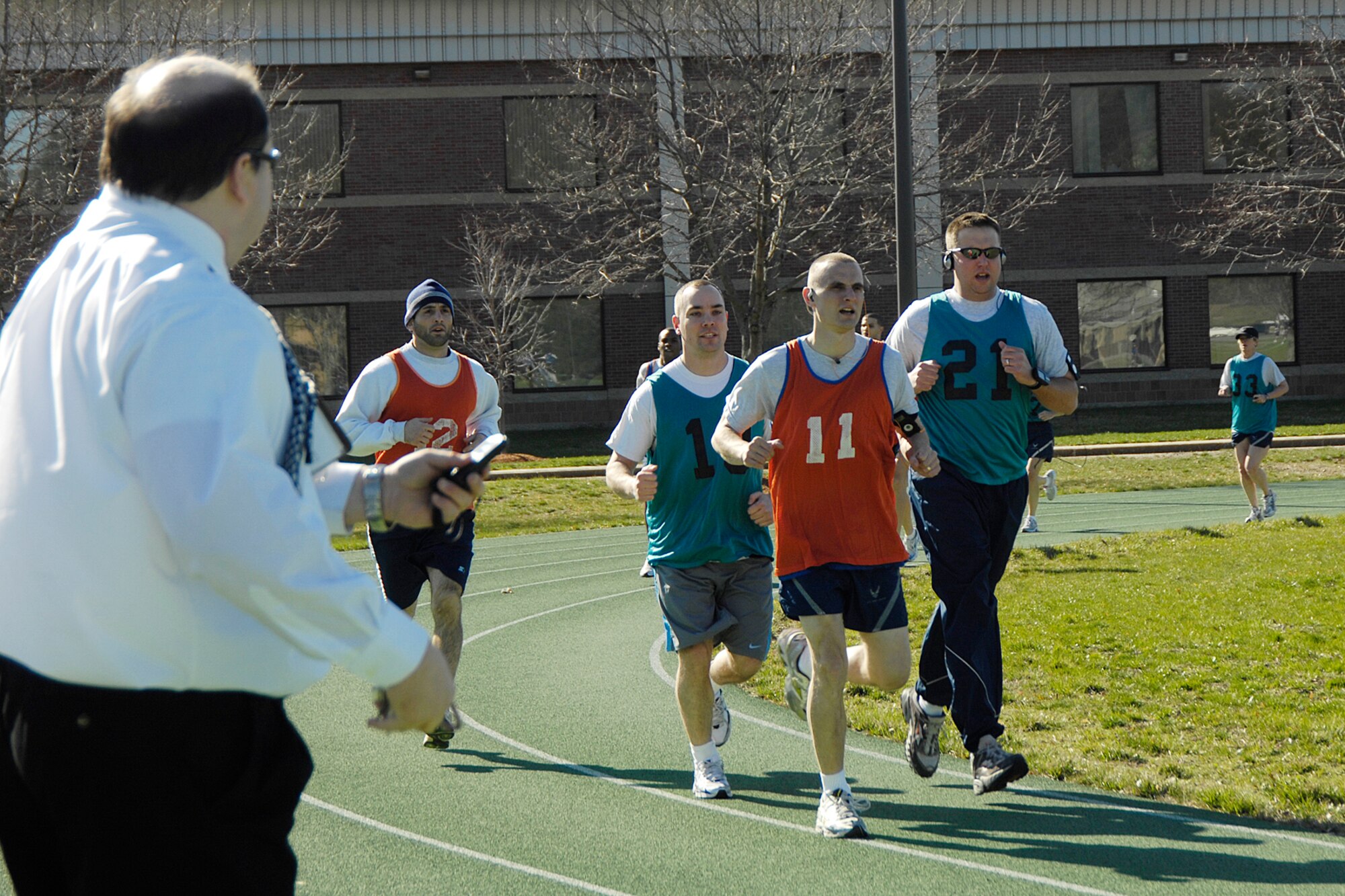 HANSCOM AIR FORCE BASE, Mass. – Airmen are timed by William Carpenter, Health and Wellness Center, during the one and a half mile run portion of the 66th Air Base Wing’s Air Force PT Challenge on April 13. (U.S. Air Force photo by Linda LaBonte Britt) 