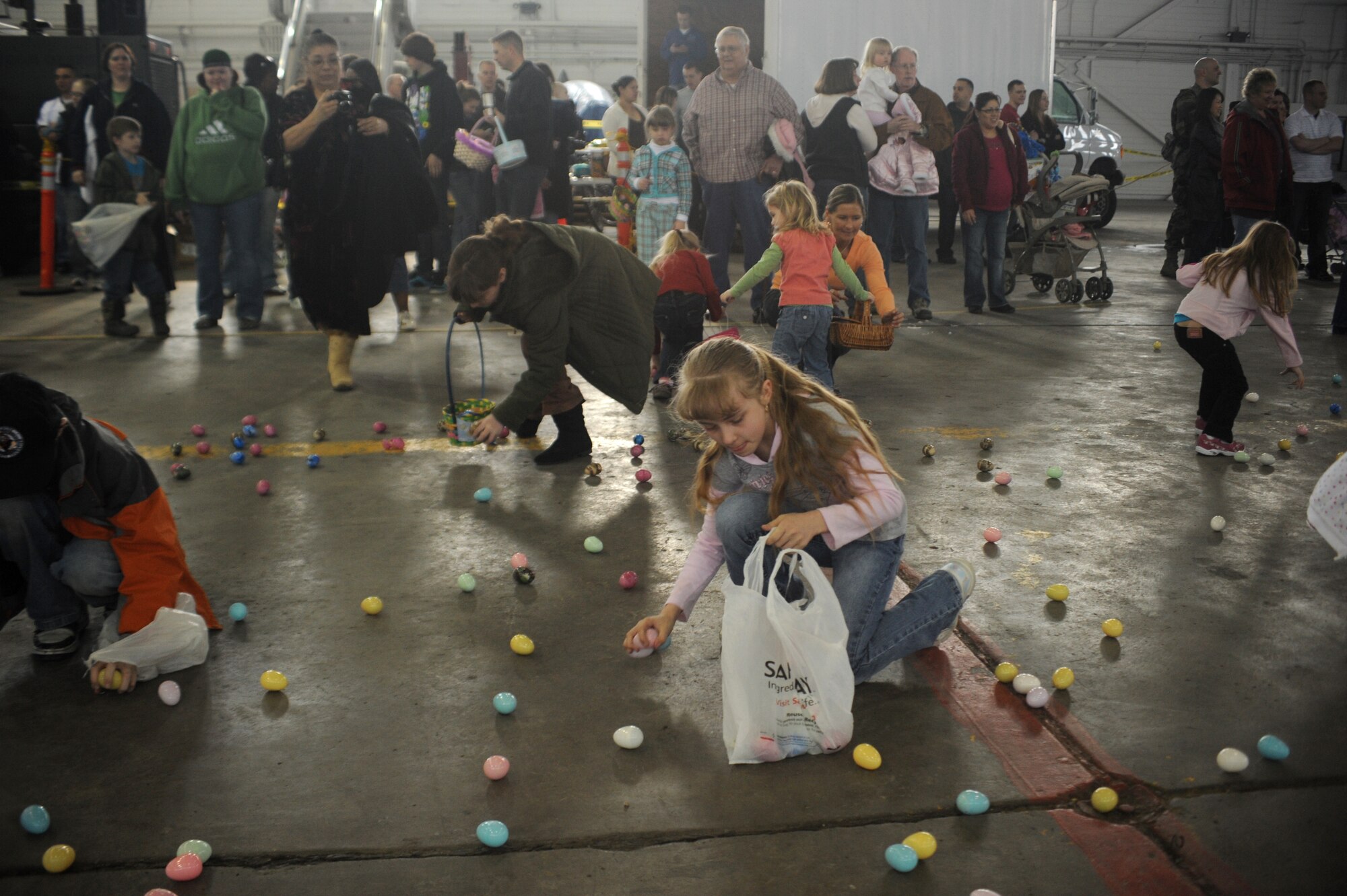 ELMENDORF AIR FORCE BASE, Alaska-- 10-year-old Catherine Olsen scrambles for Easter eggs during Elmendorf's annual Eggstavaganza on April 11, 2009. The eggs contained various items from assorted candies to gift tags that were redeemable for everything from Elmo play sets to mountain bikes. (U.S. Air Force photo by Airman First Class Kristin High)