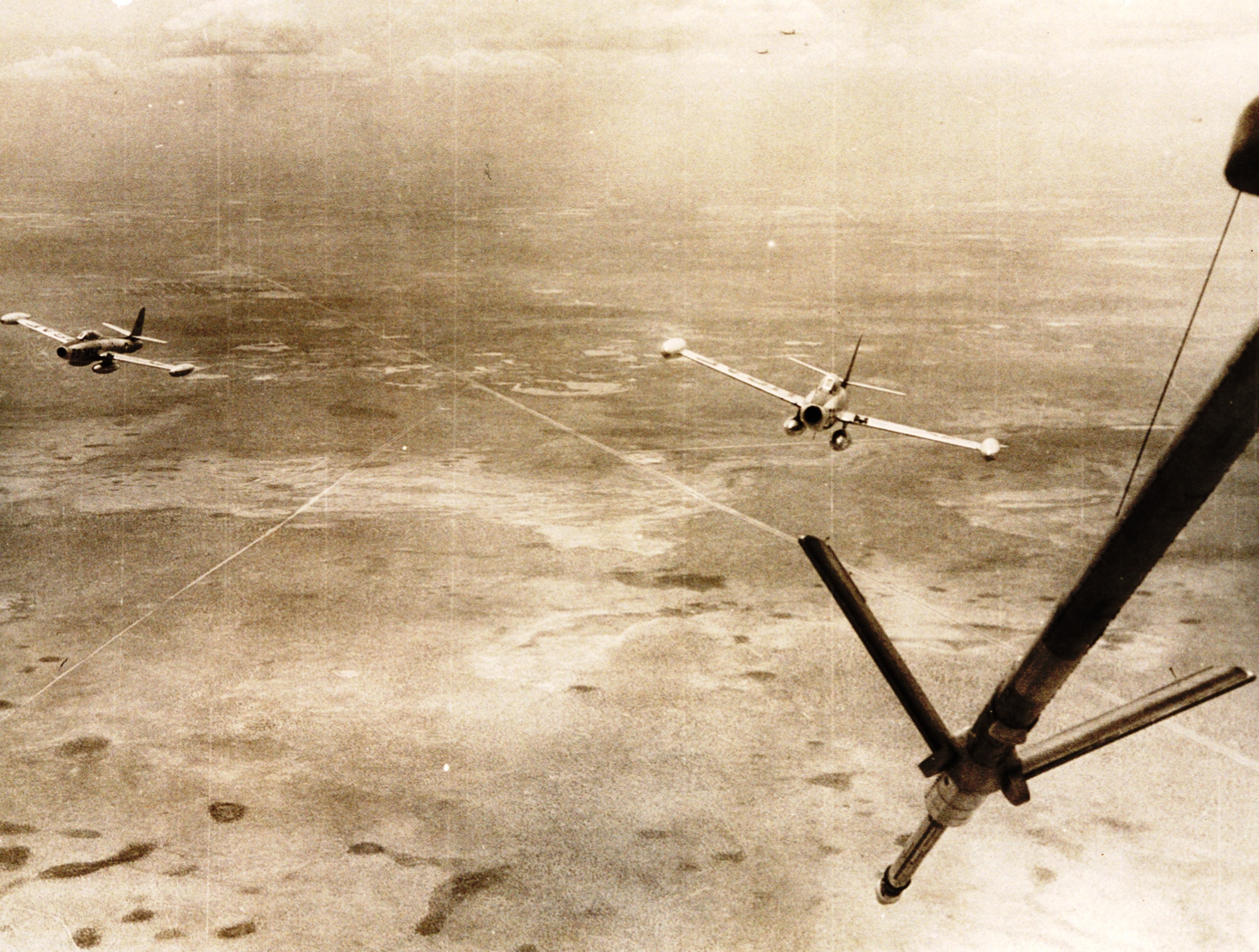 High over West Texas, two F-84Gs of the 31st Fighter Escort Wing pull in behind a waiting KB-29P during Operation Fox Peter One. (U.S. Air Force historical photo)