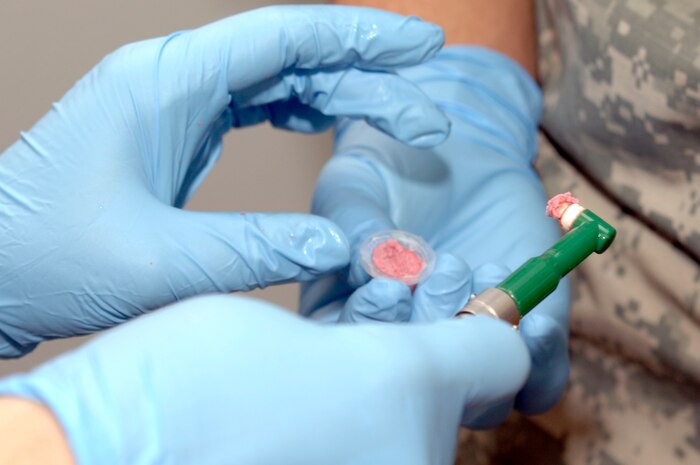 Army Capt. Sara Emanuel prepares a polisher with prophy paste during an annual dental exam at the Charleston AFB veterinary clinic April 13. The base veterinary clinic currently treats 4,800 dogs and cats per year and has a goal of booking 500 - 600 appointments per month. Captain Emanuel is the officer in charge of the veterinary clinic attached to the Tennessee Valley District Veterinary Command, Fort Jackson Branch, Charleston section. (U.S. Air Force photo/Staff Sgt. Marie Cassetty)