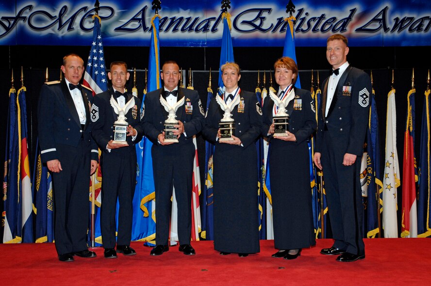 Posing with AFMC Commander Gen. Donald Hoffman are: (left to right) 96th ABW Command Chief Master Sgt. Troy Engholm, (accepting on behalf of winner Staff Sgt. Jason Forcey), 75th ABW Command Chief Master Sgt. Kevin Candler (accepting on behalf of Technical Sgt. Benjamin Horton), Master Sgt. Caroline Schmitzer, Master Sgt. Christina Kibler and AFMC Command Chief Master Sgt. William C. Gurney. AFMC honored these winners, along with all the nominees, at their 2009 Annual Enlisted Awards Banquet April 9. (Air Force photo by Al Bright) 