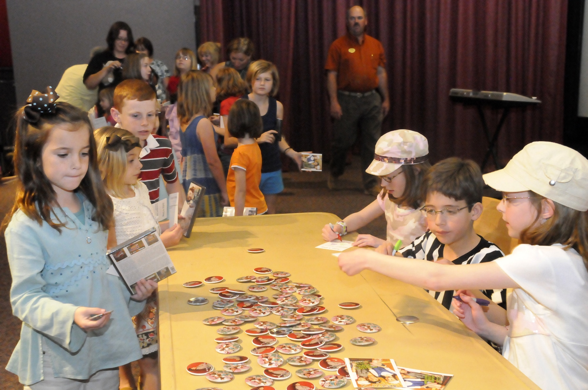 Ariel, Eli and Zoey sign autographs after their concert at Robins April 9. U. S. 
Air Force photo by Sue Sapp