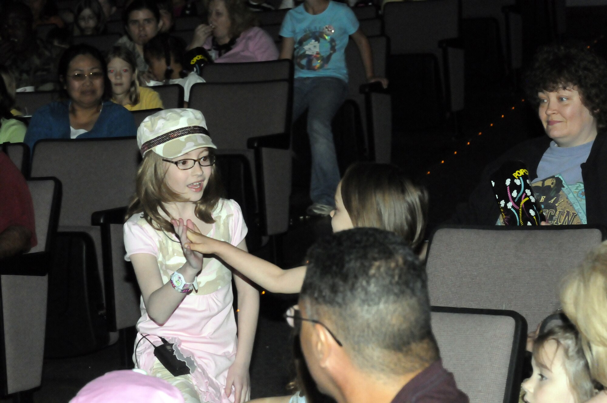 Ariel, of Ariel and Zoey, sings "The Rainbow Connection" and gives a concert attendee a high five. U. S. Air Force photo by Sue Sapp