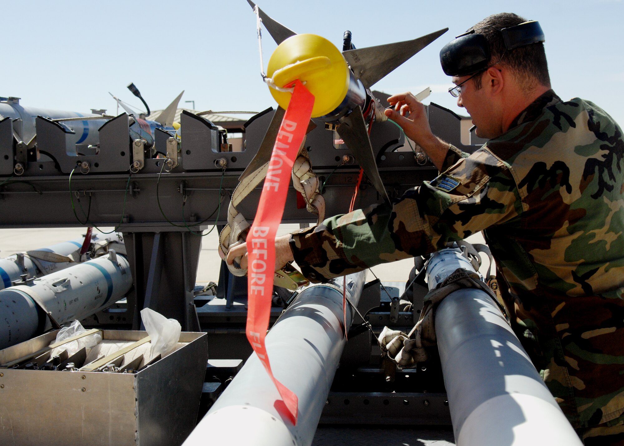Senior Airman Patrick Delucia tightens straps on an AIM-9 Sidewinder during the 49th Maintenance Group, Load Crew of the Quarter competition April 10, 2009, Holloman Air Force Base, N.M.  

 (U.S. Air Force photo/SSgt Anthony Nelson Jr)
