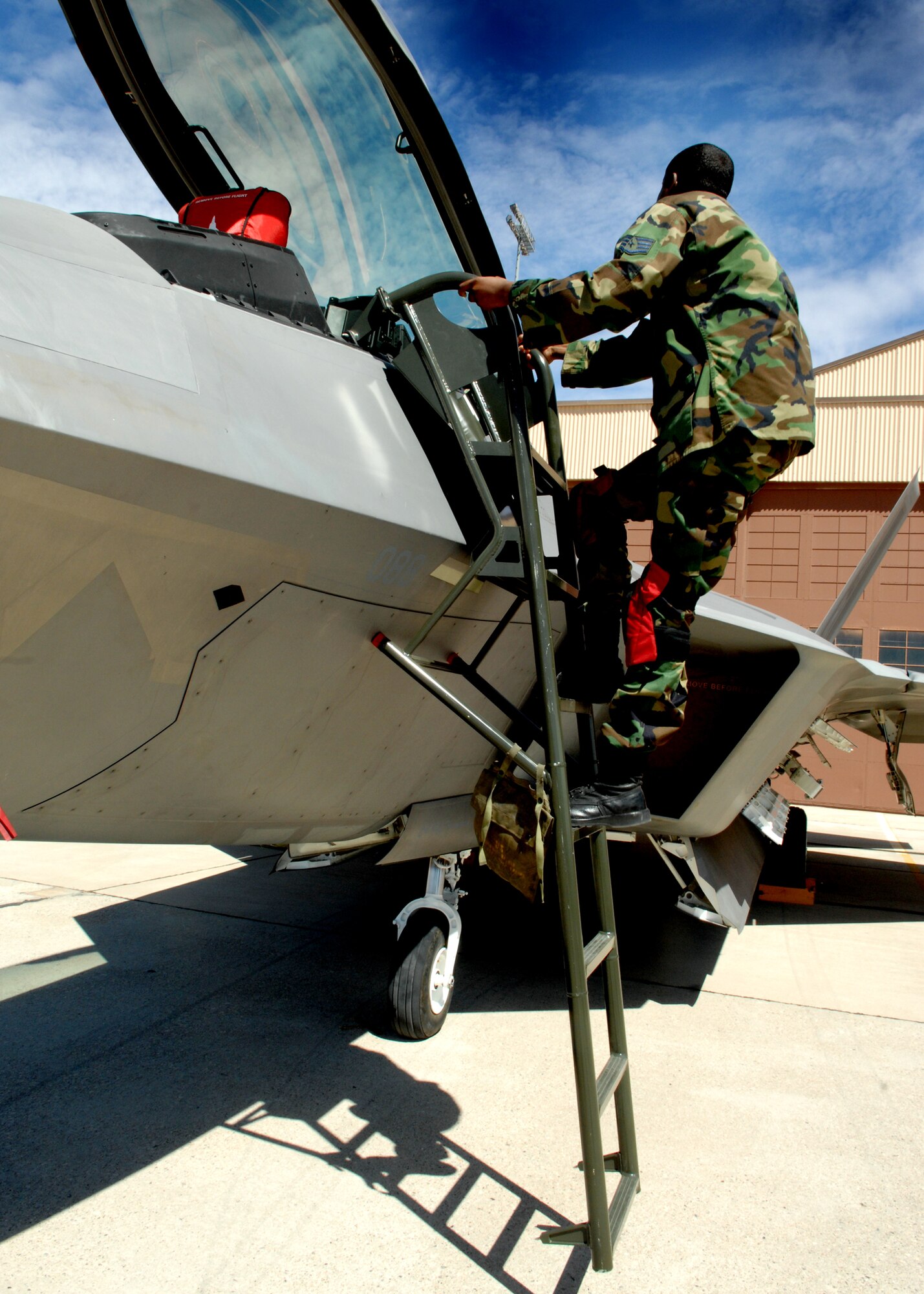 Staff Sgt. Ernest Fishburne climbs a ladder of an F-22A Raptor during the 49th Maintenance Group, Load Crew of the Quarter competition April 10, 2009, Holloman Air Force Base, N.M.

 (U.S. Air Force photo/SSgt Anthony Nelson Jr)