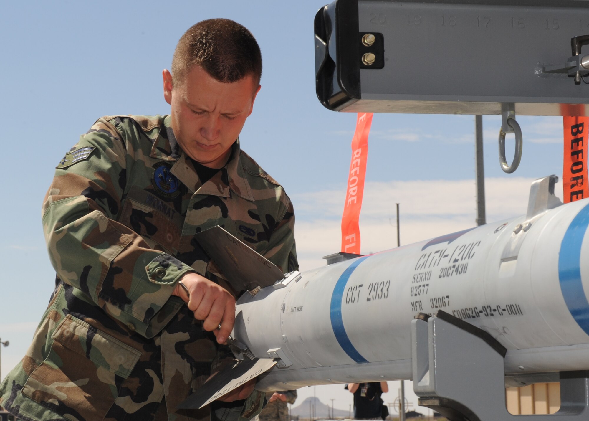 Senior Airman Ray Wornat, 49th Aircraft Maintenance Squadron, inspects an AIM-9 Sidewinder during the 49th Maintenance Group, Quarterly Load Crew competition, April 10, at Holloman Air Force Base, N.M. Squadron finalists are judged on their accuracy, efficiency, and speed. (U.S. Air Force photo/Senior Airman Michael Means)
