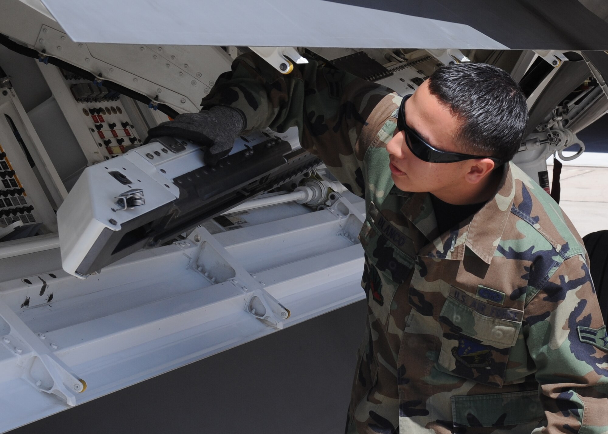 Airman 1st Class Carlos Blanco, 49th Aircraft Maintenance Squadron, checks the status of an F-22A Raptor before loading the missle during the Quarterly Load Crew competition, April 10, at Holloman Air Force Base, N.M.  (U.S. Air Force photo/Senior Airman Michael Means)