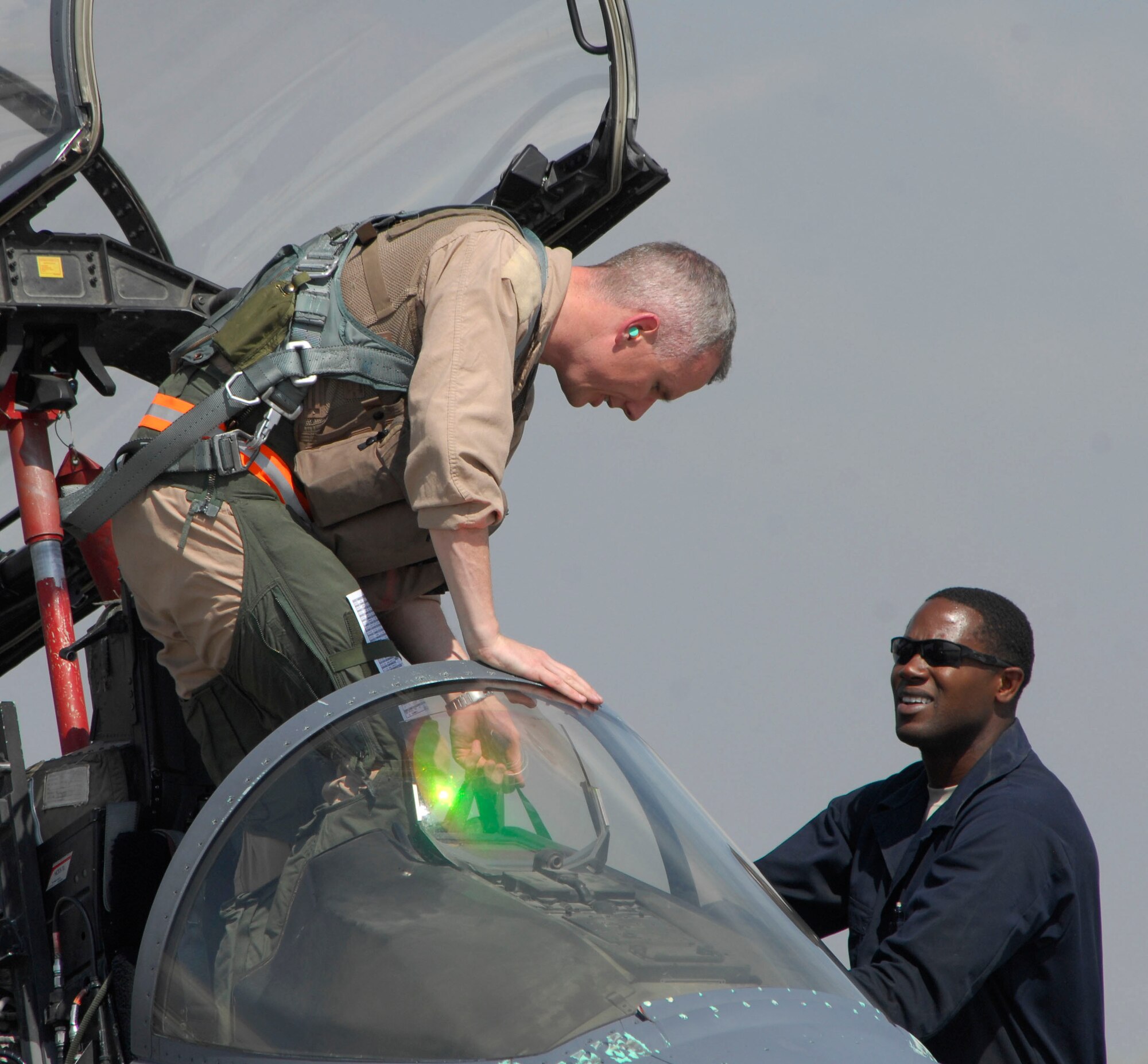 Lt. Col. Charles Wallace, 455th Air Expeditionary Wing, is greeted by Airman 1st Class Joshua Carethers, 455th Expeditionary Aircraft Maintenance Squadron, as he returns from a close air support mission. The F-15E "Strike Eagle's" primary mission is to provide close air support to U.S. and coalition ground troops in Afghanistan. Colonel Wallace is deployed from Seymour-Johnson Air Force Base, N.C. Airman Carethers is deployed from Royal Air Force Lakenheath, England. (U.S. Air Force photo/ Senior Airman Erik Cardenas)(Released)