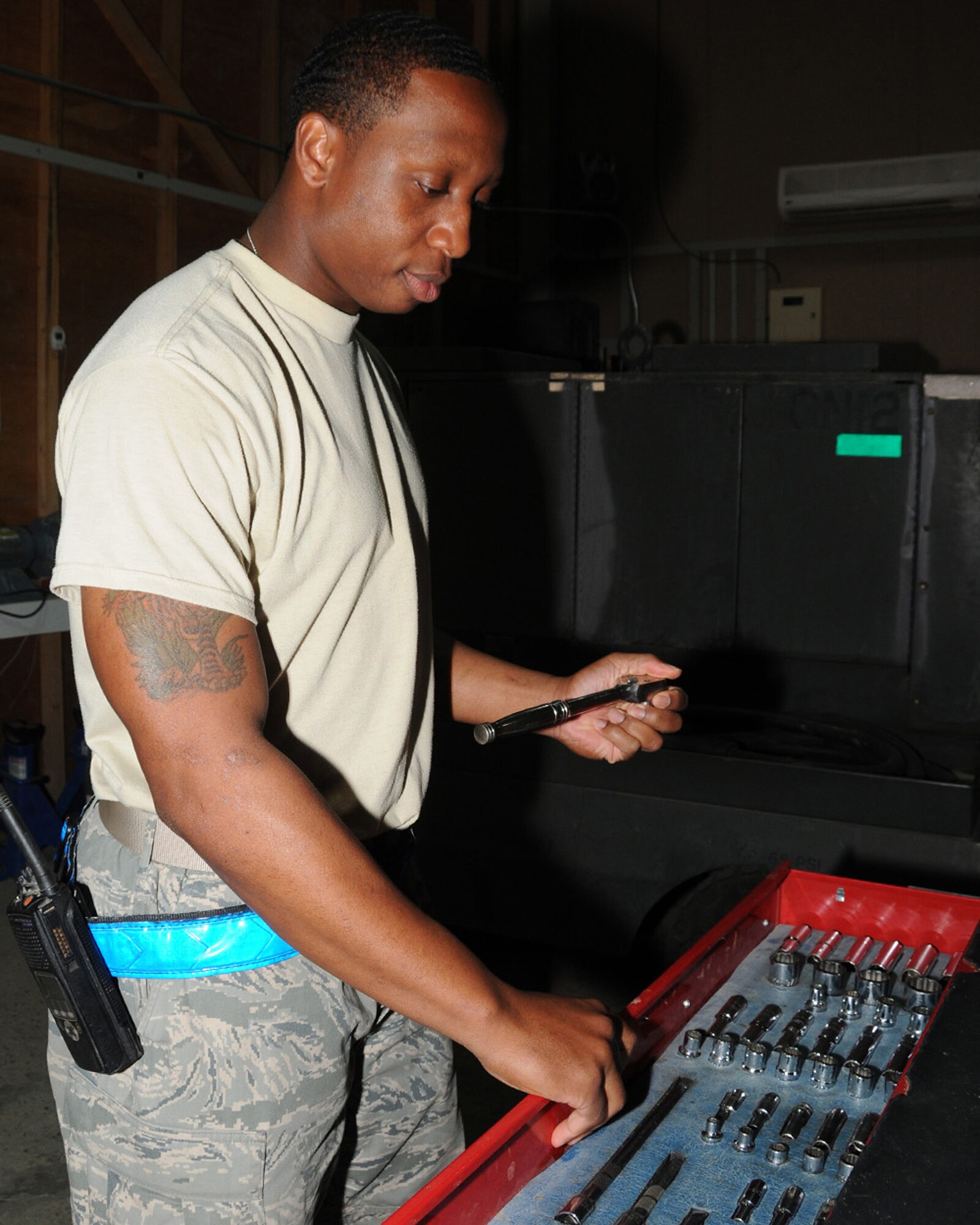 SOUTHWEST ASIA -- Staff Sgt. Elliot White, 386th Expeditionary Maintenance Squadron aerospace ground equipment mechanic, searches for the correct tools to remove and replace a tire on a mobile A/C unit at an air base in Southwest Asia, April 11. Aerospace ground equipment maintainers are responsible for the maintenance, inspections, test and operations of all ground equipment in support of aircraft maintenance and flying operations. Sergeant White is currently deployed from Davis-Monthan Air Force Base, Ariz., and is originally from Cleveland. (U.S. Air Force photo/ Senior Airman Courtney Richardson)