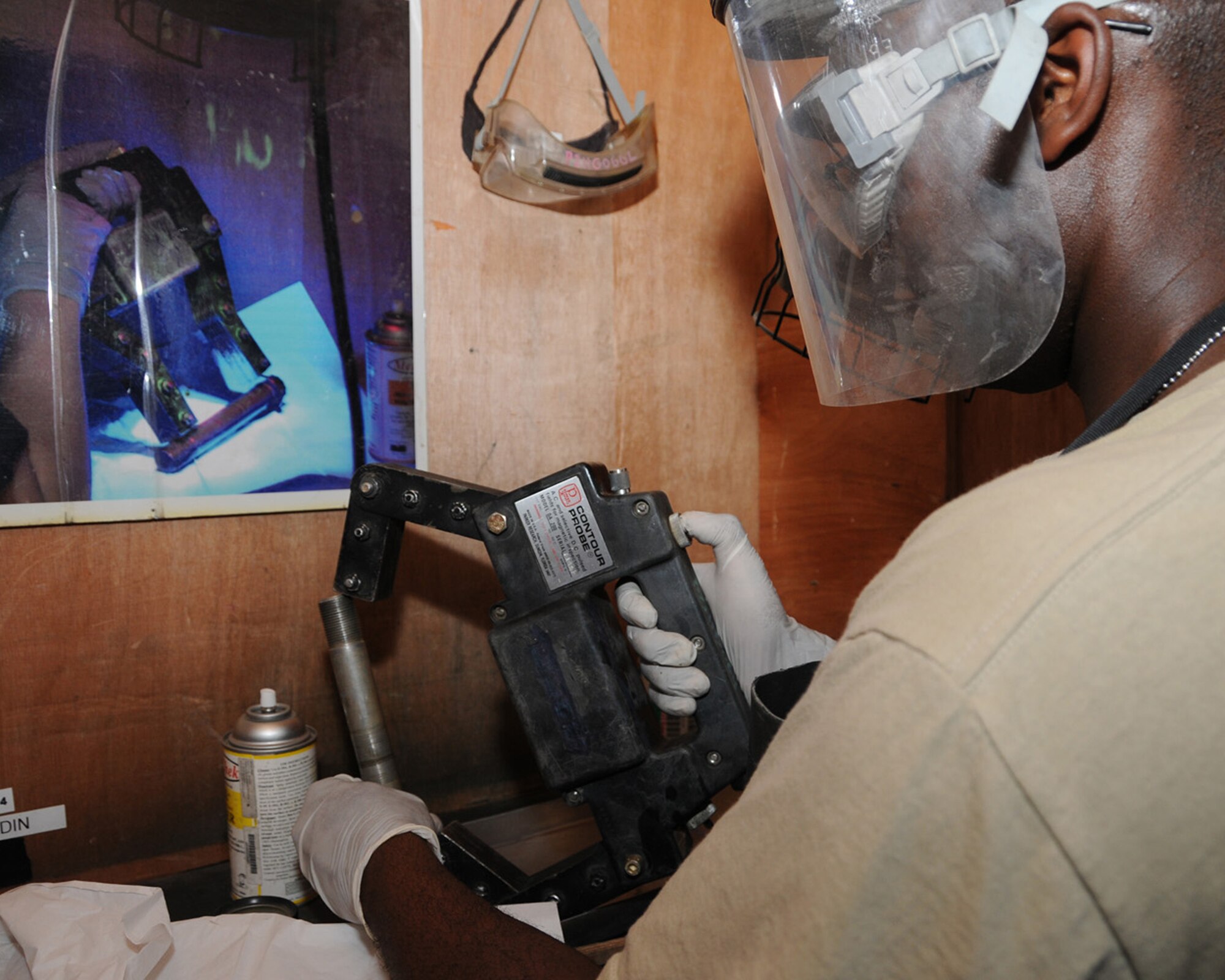 SOUTHWEST ASIA -- Staff Sgt. James Cone, 386th Expeditionary Maintenance Squadron, uses a DA 200 Parker Probe, a magnet used to produce a magnetic field, on a bolt at an air base in Southwest Asia, April 11. Once a piece of equipment is properly magnetized, it is lightly coated with a Fluorescent Magnetic Particle spray which contains tiny metal particles that fluoresce when placed under a black light, revealing any cracks. Sergeant Cone is currently deployed from Dyess Air Force Base, Texas and is originally from Jacksonville, Ark. (U.S. Air Force photo/ Senior Airman Courtney Richardson)