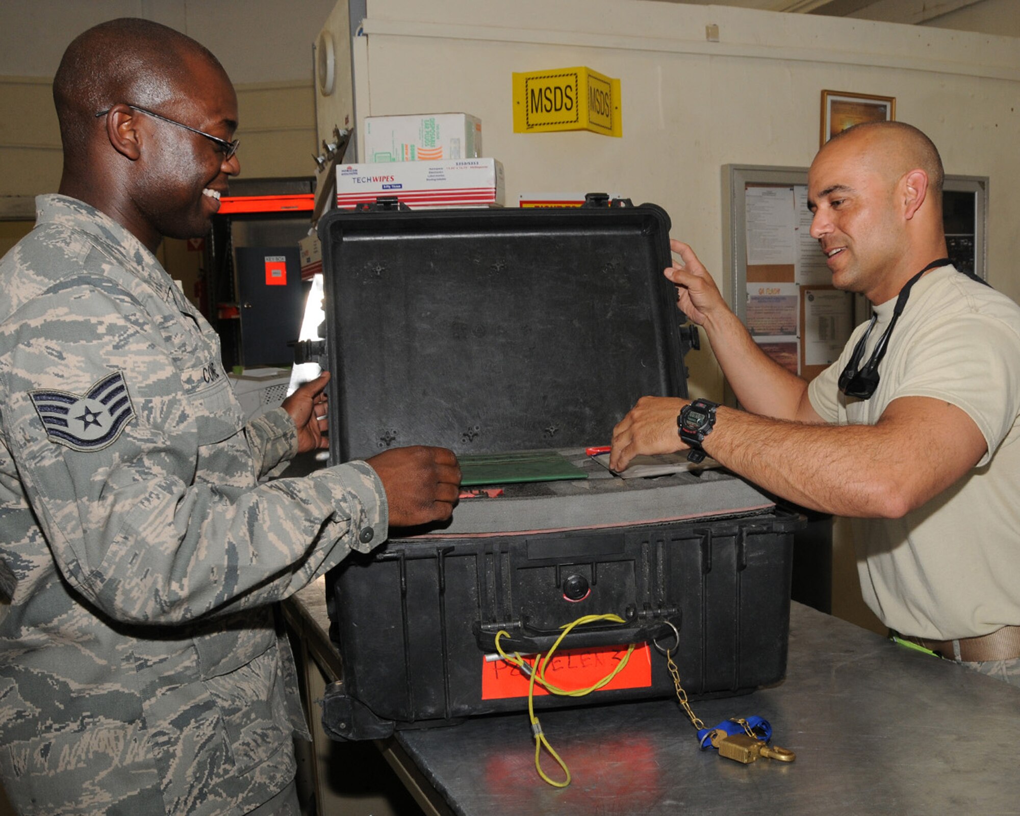 SOUTHWEST ASIA -- Tech. Sgt. Mark Aviles, 386th Expeditionary Maintenance Squadron, sign outs tools from Staff Sgt. James Cone, 386th EMXS, at an air base in Southwest Asia, April 11. Before checking out equipment, all tools must be verified, accounted for and checked for serviceability. Sergeant Aviles is currently deployed from Ramstein Air Base, Germany, and is originally from Puerto Rico. Sergeant Cone is currently deployed from Dyess Air Force Base, Texas, and is originally from Jacksonville, Ark. (U.S. Air Force photo/ Senior Airman Courtney Richardson)