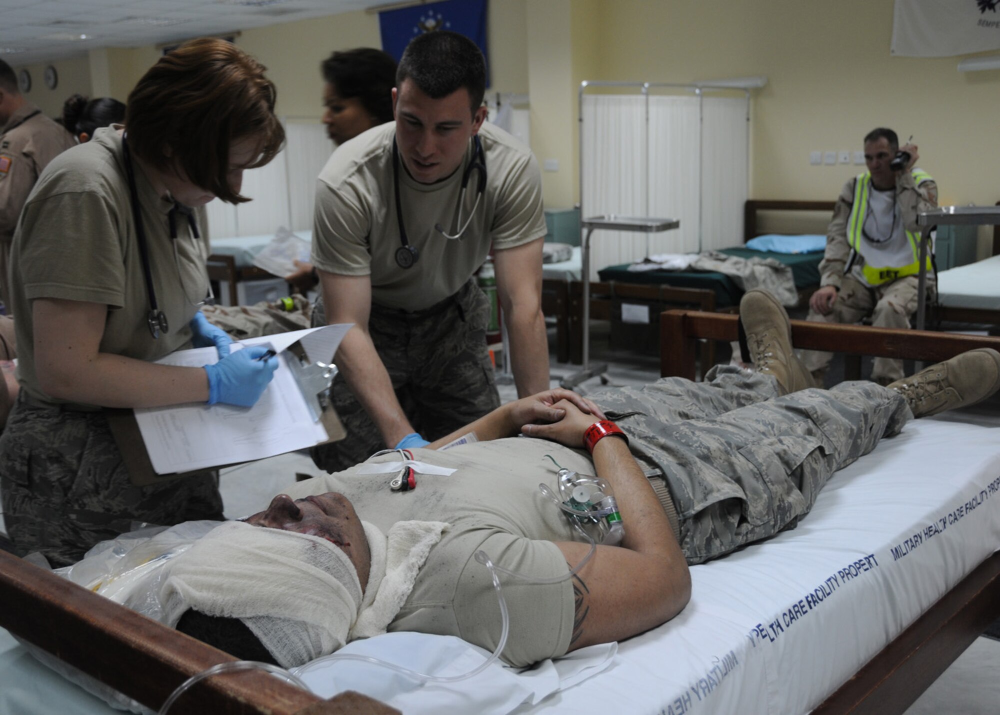 SOUTHWEST ASIA -- Capt. Donald Euler, 386th Expeditionary Medical Group ground critical care team chief, reviews a simulated patient's condition while 1st Lt. Heather Keen, 386th EMDG clinical nurse, scribes his observations on the simulated patient's chart during a Base Response and Readiness Exercise at an air base in Southwest Asia, April 13.  Once a patient is transferred from the scene to the nearest medical facility they are closely monitored until their condition becomes stable or until they are transferred to another facility for specialized care. Captain Euler and Lieutenant Keen are both currently deployed from Wright-Patterson Air Force Base, Ohio. Captain Euler is originally from Chattanooga, Tenn., and Lieutenant Keen is originally from Hastings, Neb. (U.S. Air Force photo/ Senior Airman Courtney Richardson)