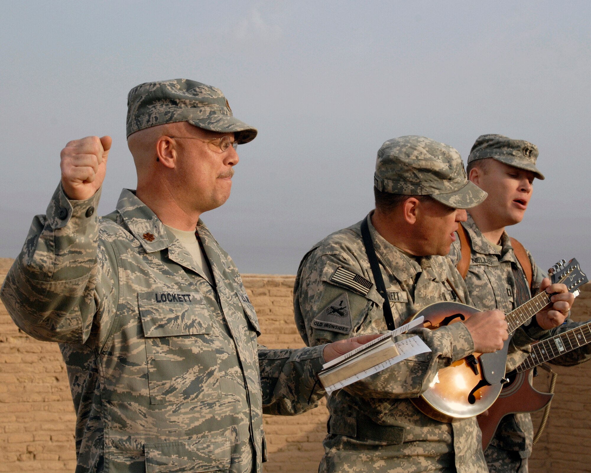 ALI BASE, Iraq – Chaplain (Maj.) Kevin Lockett, 407th Air Expeditionary Group Protestant chaplain, (right) sings a hymn with Army chaplains from Contingency Operating Base Adder prior to delivering his Easter Sunrise Service sermon April 12 from atop the walls of Abraham’s home. The biblical story of Abraham—revered by the Jewish, Christian and Islamic faiths—is found in the Book of Genesis. Chaplain Lockett is deployed from the 319th Air Refueling Wing, Grand Forks Air Force Base, N.D. His hometown is Rockford, Ill. (U.S. Air Force photo/Master Sgt. Russell P. Petcoff)