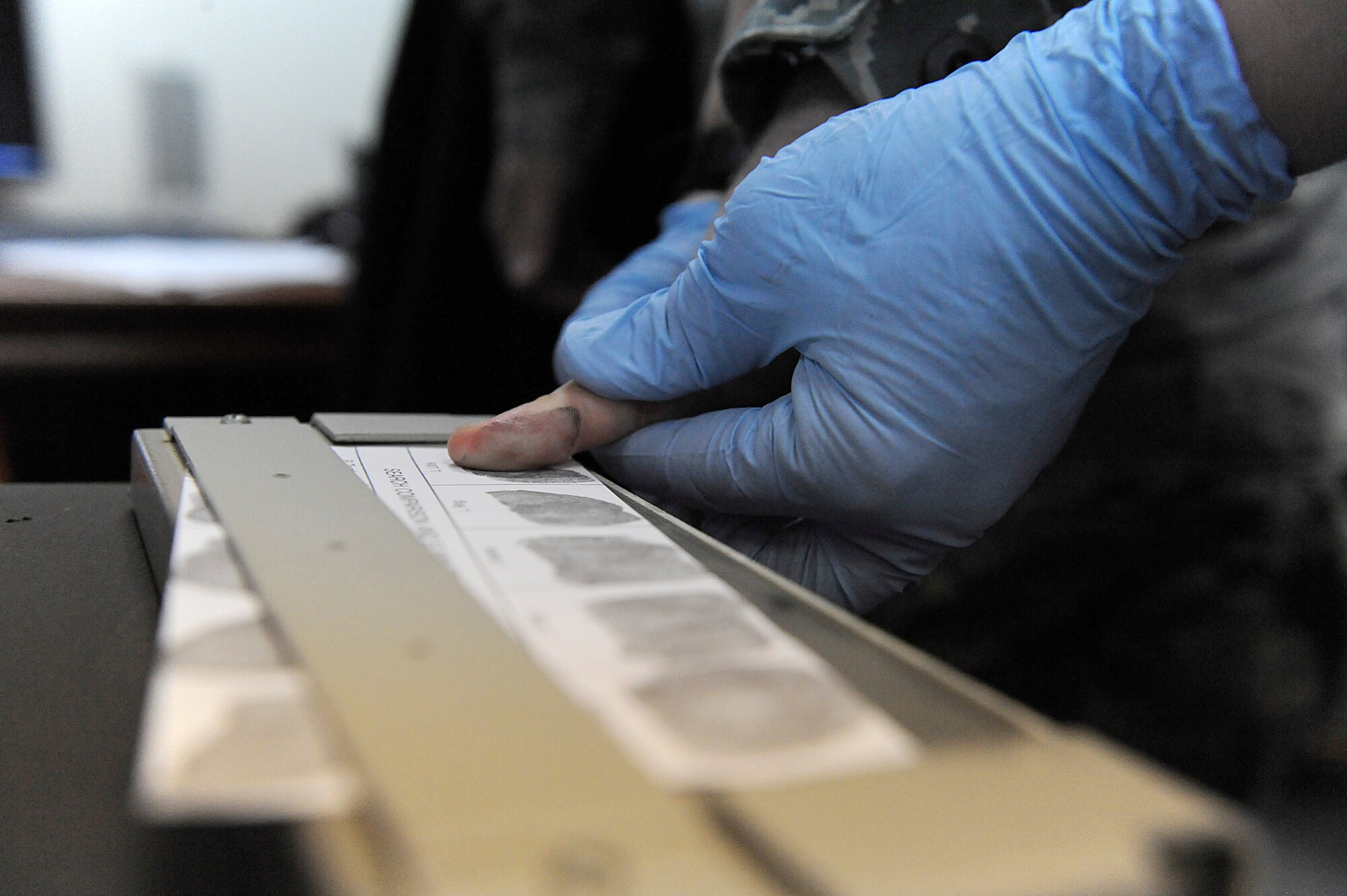 A "suspect" gets finger printed during a mock investigation at the 380th Air Expeditionary Wing at an undisclosed location in Southwest Asia, April 11. Prints were taken from a glass and will be matched against the ones taken of the suspect to determine who was involved with the crime. (U.S. Air Force photo by Senior Airman Brian J. Ellis) (Released)