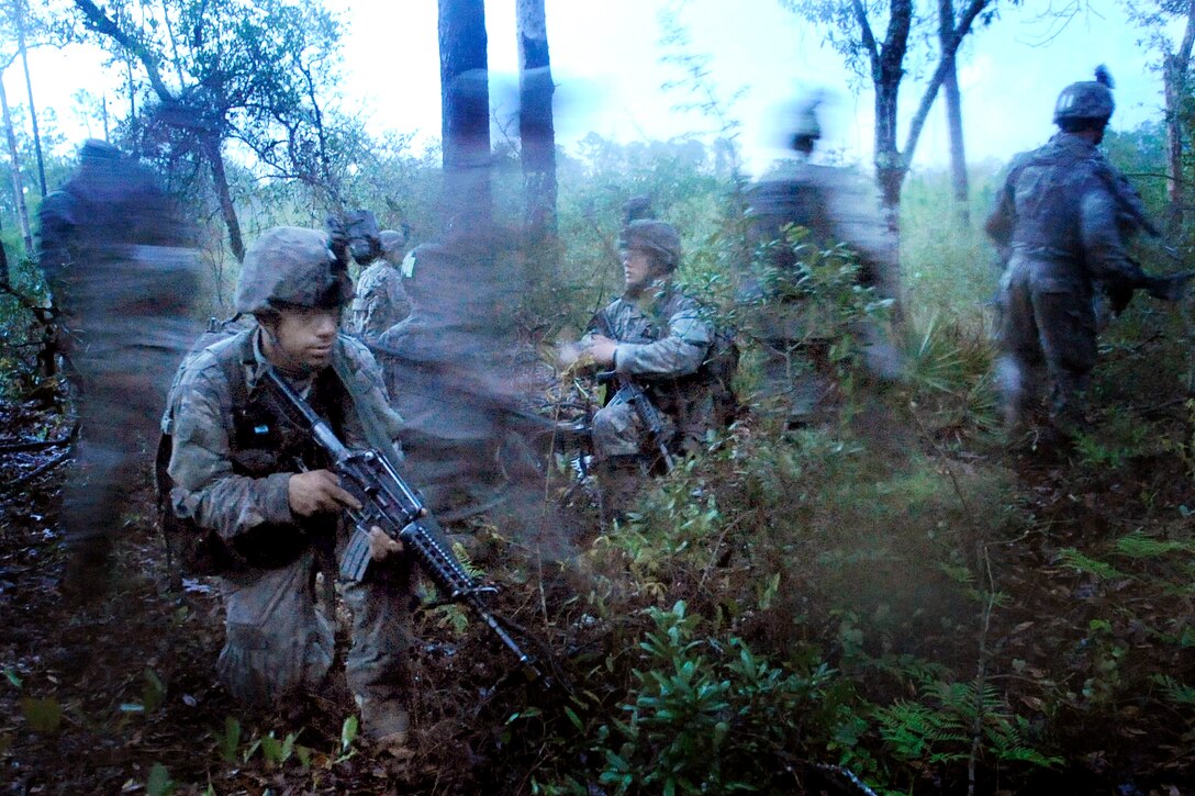 A company of U.S. Army Rangers silently negotiate their way to an enemy objective while participating in the third phase of Ranger training on Camp James E. Rudder, Florida, April 13, 2009. There are three phases in Ranger training: the Benning Phase on Fort Benning Ga., the Mountain Phase in Dahlonega, Ga., and the Florida Phase on Camp James E. Rudder, Fla.