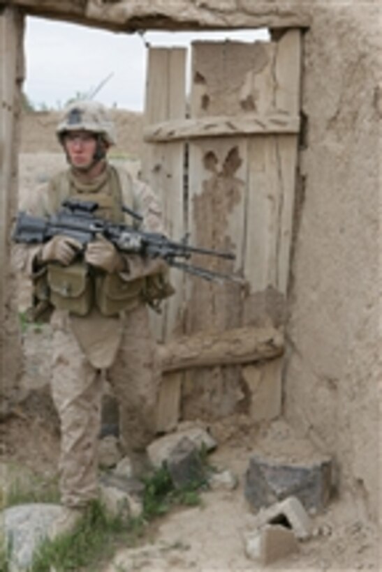 U.S. Marine Corps Lance Cpl. Todd Pedilla, a rifleman with Lima Company, 3rd Battalion, 8th Marine Regiment, enters a compound to set up an over watch position during a local security patrol in Helmand province, Afghanistan, on April 9, 2009.  The Marines are conducting security patrols in their area of operation to prevent enemy freedom of movement. The 3rd Battalion is the ground combat element of Special Purpose Marine Air Ground Task Force - Afghanistan.  