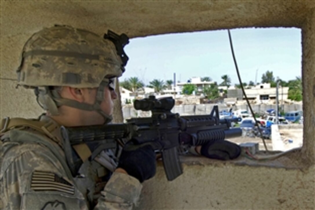 U.S. Army Spc. Anthony Locke provides security from a window at an Iraqi police station in Daliabas, Iraq, April 13, 2009. Locke is assigned to the 25th Infantry Division's 3rd Battalion, 21st Infantry Regiment, 1st Stryker Brigade Combat Team.