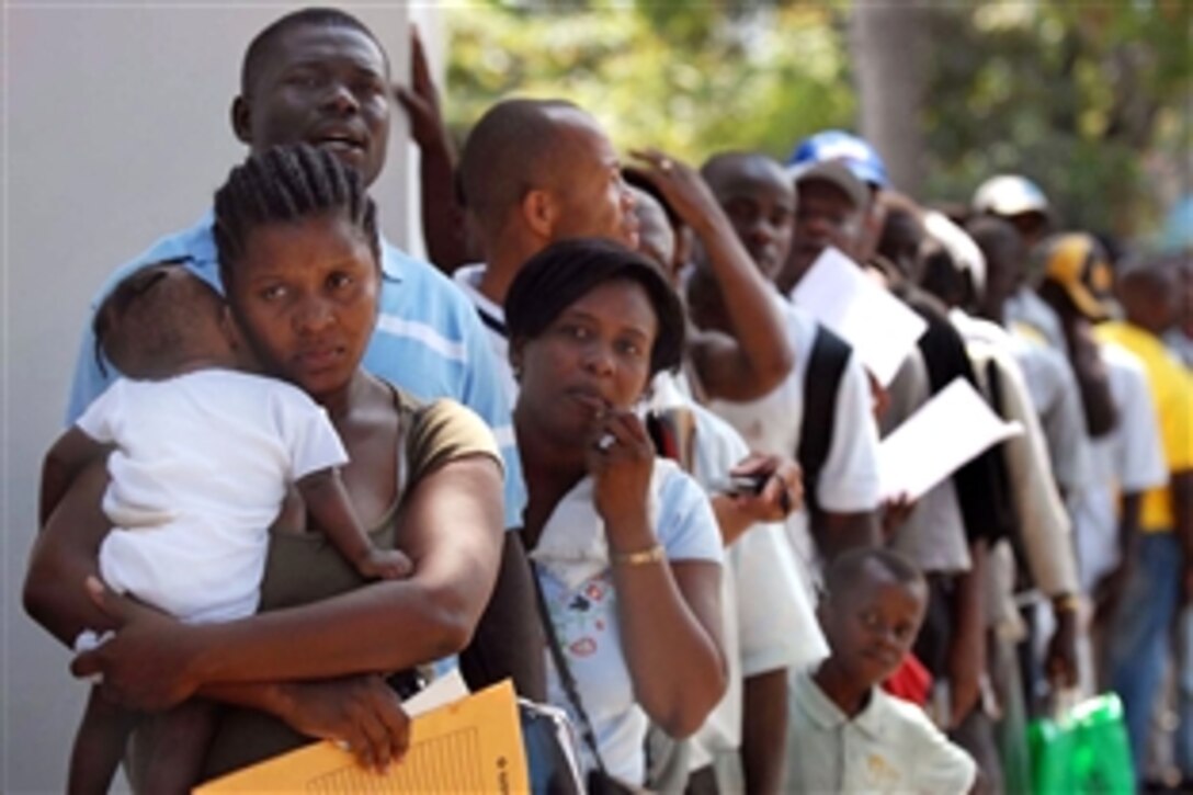 Haitians line up for medical treatment by physicians from the military hospital ship USNS Comfort during its Continuing Promise 2009 mission in Killick, Haiti, April 10, 2009. Continuing Promise is a four-month humanitarian and civic assistance mission between the United States and international partners to provide support programs afloat and ashore in seven countries in Latin America and the Caribbean.