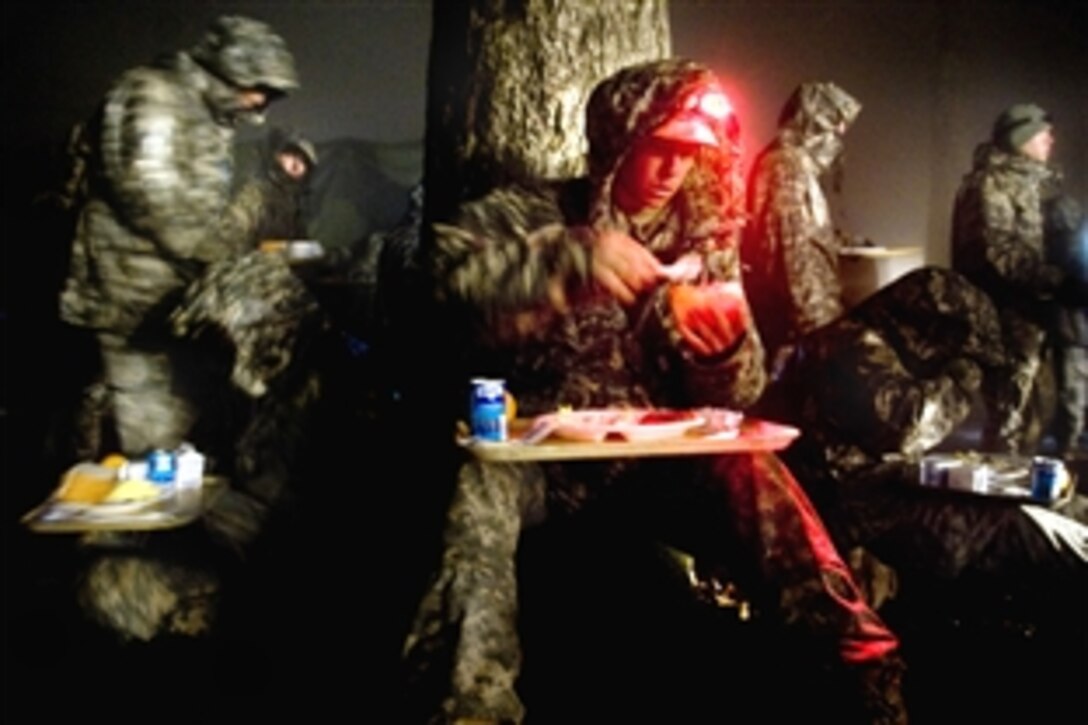 U.S. Army Rangers find a place to eat their first hot meal in days while tolerating the rain during mountaineering training in Dahlonega, Ga., April 13, 2009. The Rangers face three phases of training: the Benning Phase on Fort Benning Ga., Mountain Phase in Dahlonega, Ga., and the Florida Phase on Camp James E. Rudder, Fla.