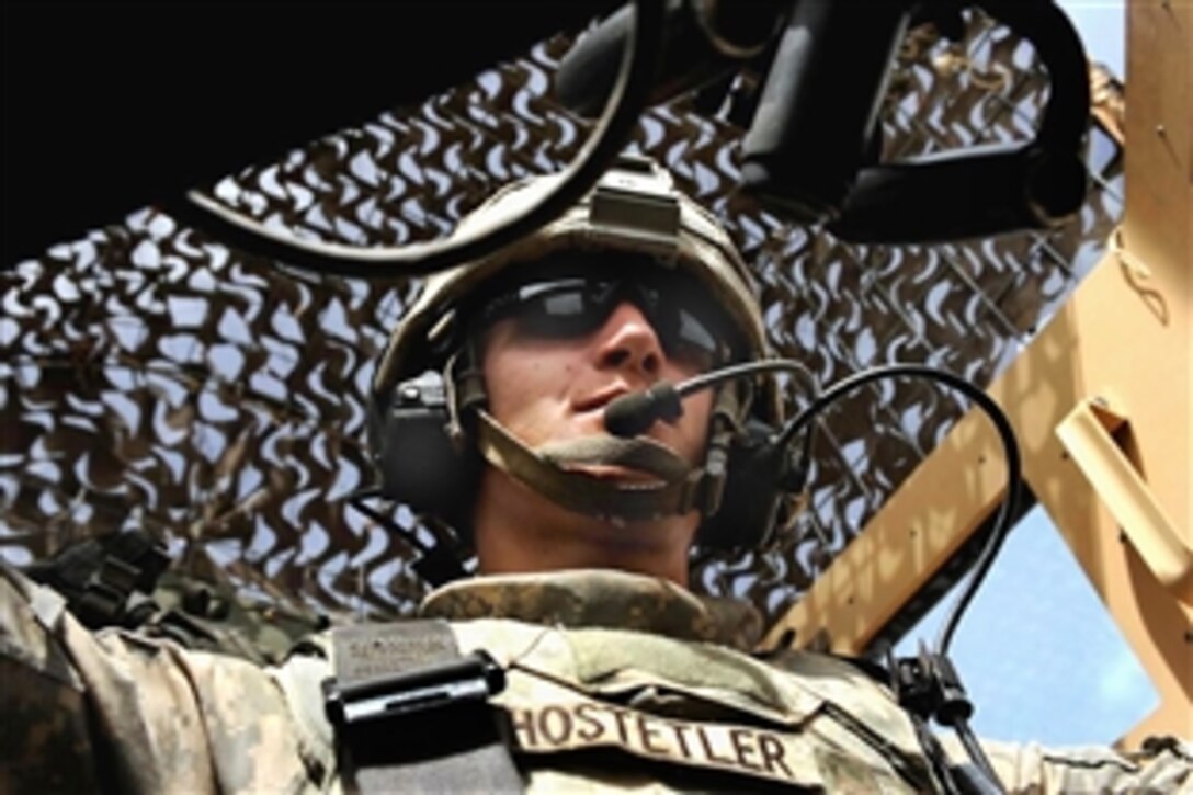 U.S. Army Pfc. Jason Hostetler scans his sector from the turret of an armored vehicle during a patrol to survey residents in Ghammas, Iraq, April 7, 2009. Hostetler is assigned to the 4th Infantry Division's 2nd Brigade Combat Team.
