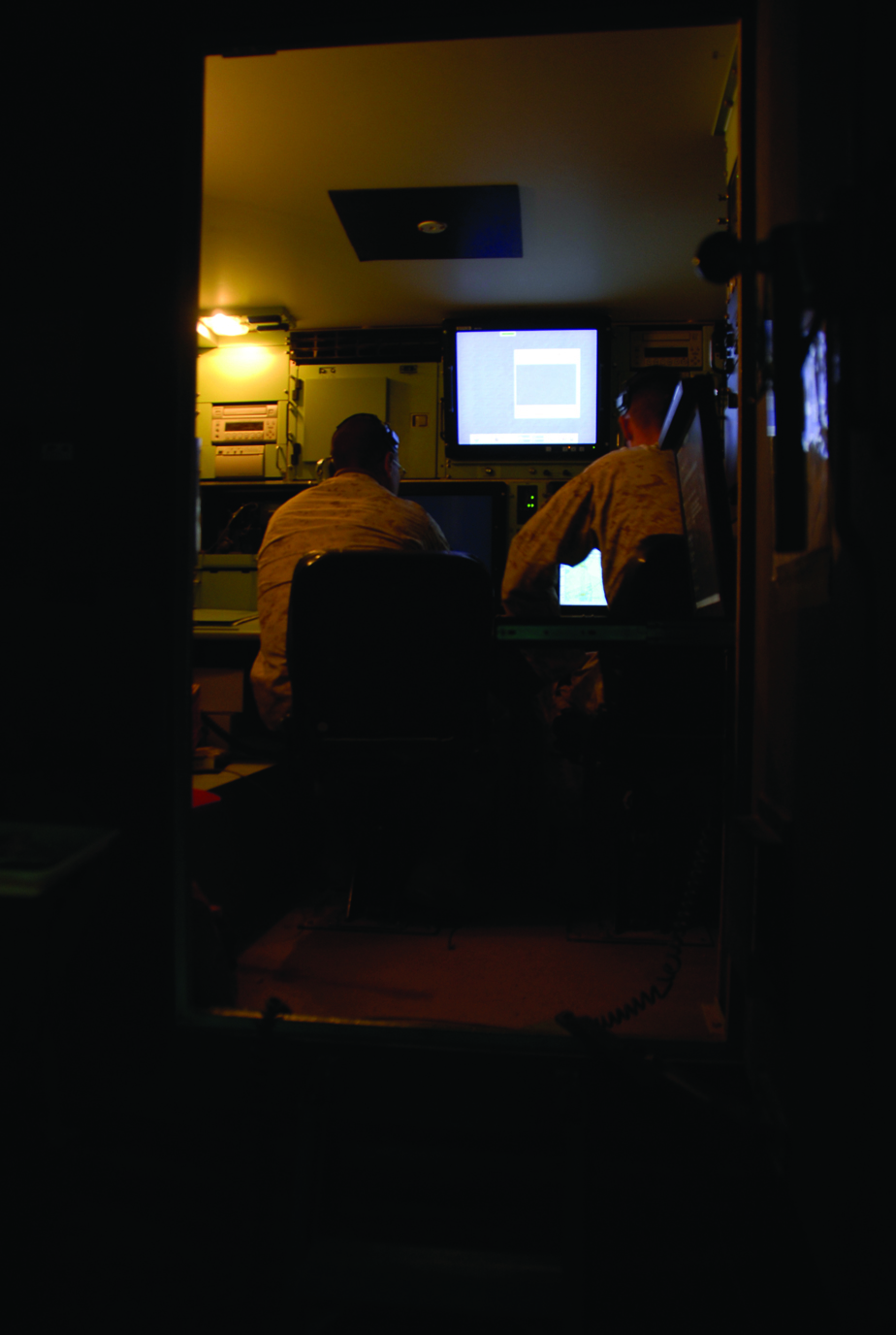 Marine Unmanned Aerial Vehicle Squadron 3 operators work in a control station April 15, 2009 to manage the unmanned aerial aircraft on the Barry M. Goldwater Range. Control and monitoring can be transferred between the two stations that come with the RQ-7B Shadow 200 system.