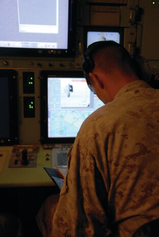 A Marine Unmanned Aerial Vehicle Squadron 3 Marine monitors the UAV from a ground control station April 15, 2009 out of the Tacts field in the Barry M. Goldwater Range. Control and monitoring can be transferred between the two stations that come with the RQ-7B Shadow 200 system.
