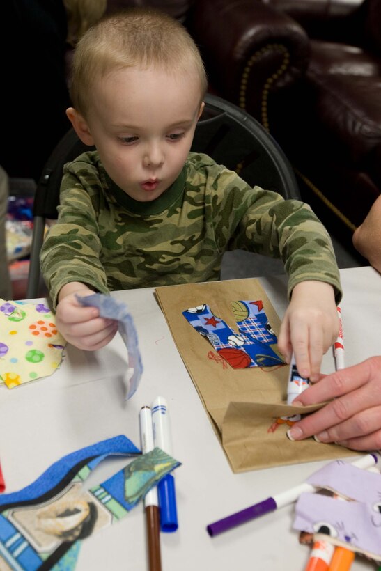 A little boy makes a puppet for his parents during the Kids Coping Workshop at the Wounded Warrior Battalion-East, April 16. The workshop focused on helping kids deal with their parents injuries. The kids made journals and other crafts while the parents attended a parenting workshop, which focused on improving parenting techniques.