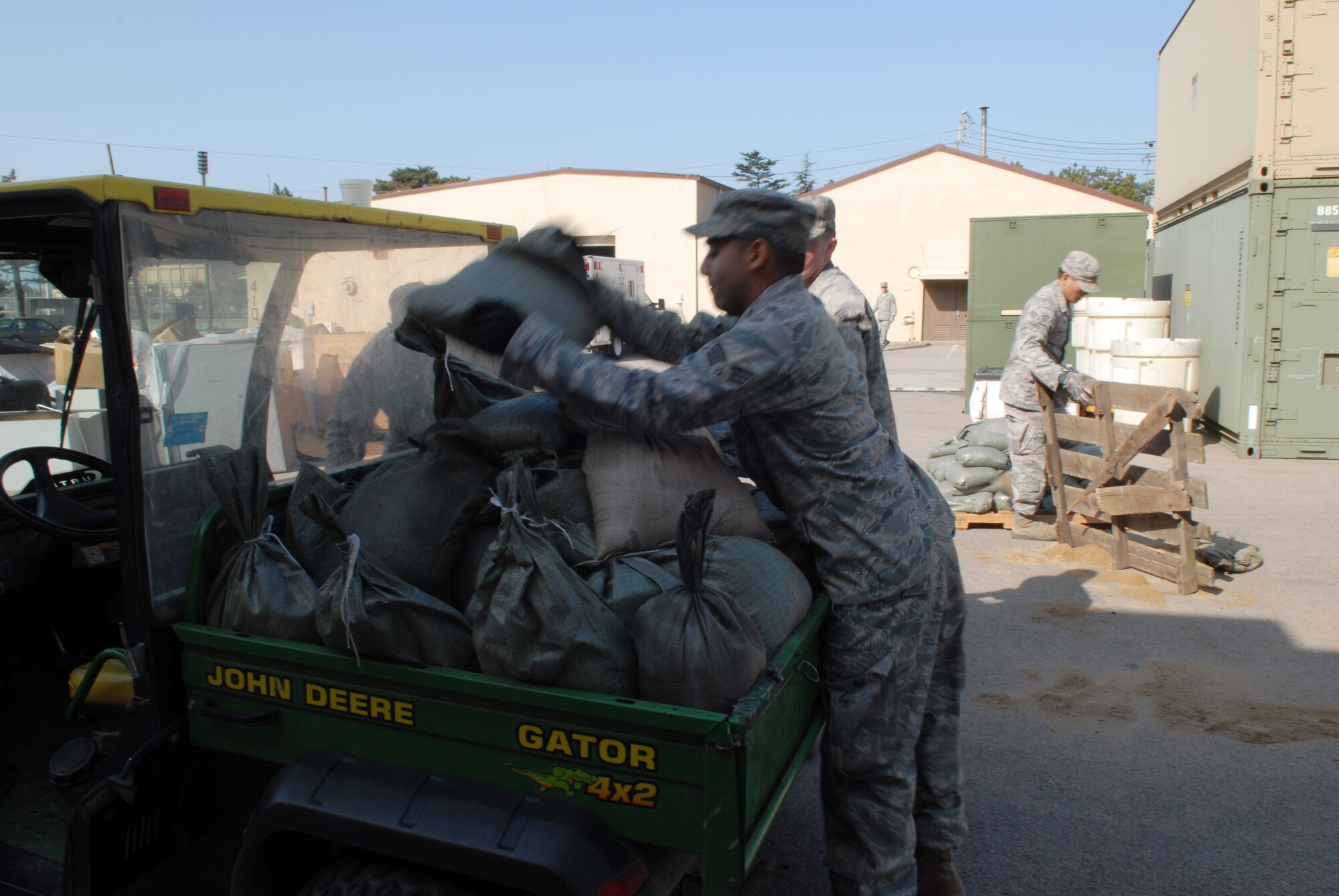Senior Airman Nathaniel Smith, along with other Airmen from the 8th Medical Group, gather sand bags in order to build up and harden the 8th Medical Group facilities in preparation for the upcoming Operational Readiness Inspection at Kunsan Air Base, Republic of Korea, April 17, 2009. Build up and hardening of facilities on base is a vital part of preparation for the upcoming ORI. (U.S. Air Force Photo by: Senior Airman Angela Ruiz)
