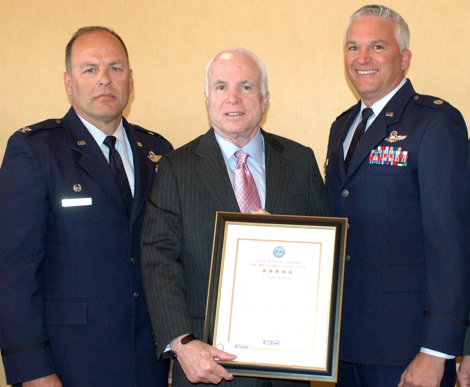 Col. Greg Stroud, left, 162nd Fighter Wing commander, and Lt. Col. Ed Maxwell, vice wing commander, present U.S. Senator John McCain with an ESGR certificate of support, April 16, for his work in Congress to pass legislation supporting the Reserve component. (Air National Guard photo by Capt. Gabe Johnson)