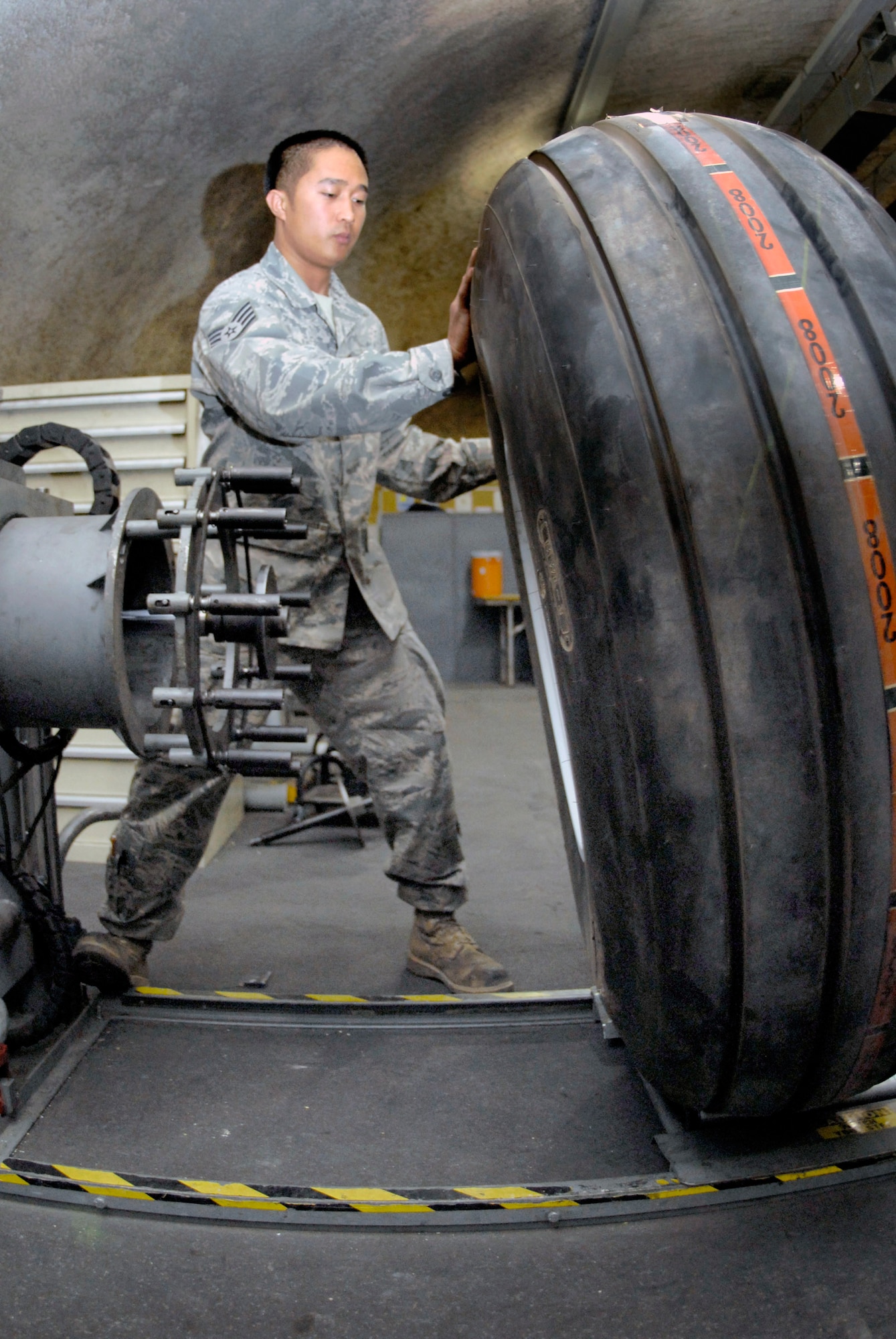 Staff Sgt. Ruben Ramones rolls a C-130 Hercules tire to the air filling station April 13 after assembling the main wheel components at an air base in Southwest Asia. Sergeant Ramones hails from Sacramento, Calif., and is deployed from Yokota Air Base, Japan, in support of Operations Iraqi and Enduring Freedom and Combined Joint Task Force - Horn of Africa. He is the wheel and tire shift lead for the 379th Expeditionary Maintenance Squadron. (U.S. Air Force photo/Senior Airman Andrew Satran)