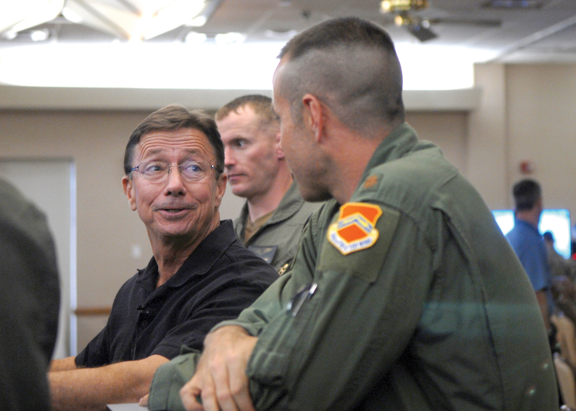 Retired Col. Billy Diehl speaks with Maj. Jason Hokaj, 56th Fighter Wing flying executive officer, during the Warrior Call.  (U.S. Air Force photo/ Airman 1st Class Ronifel Yasay.)