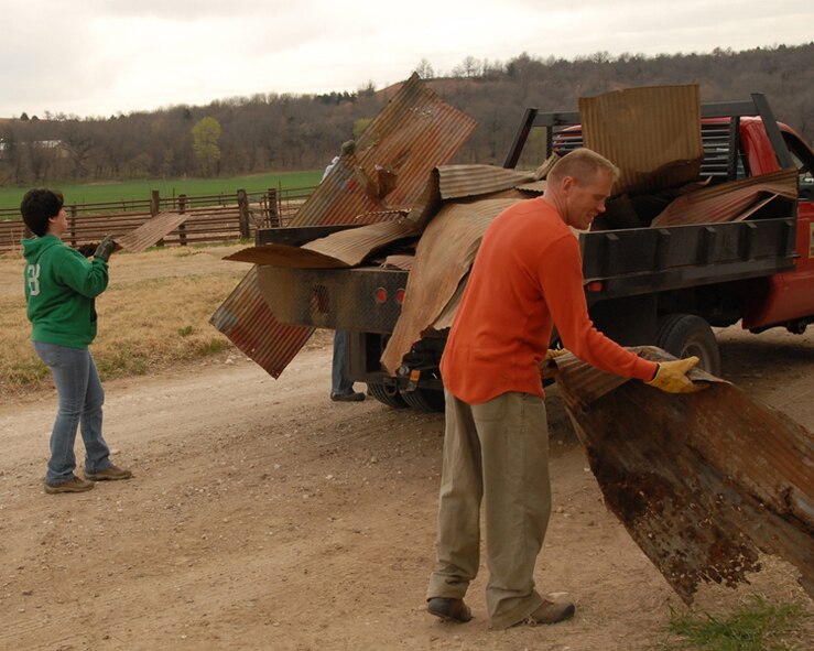 TSgt Diane McNany and TSgt Mark Wall load debris onto a truck
