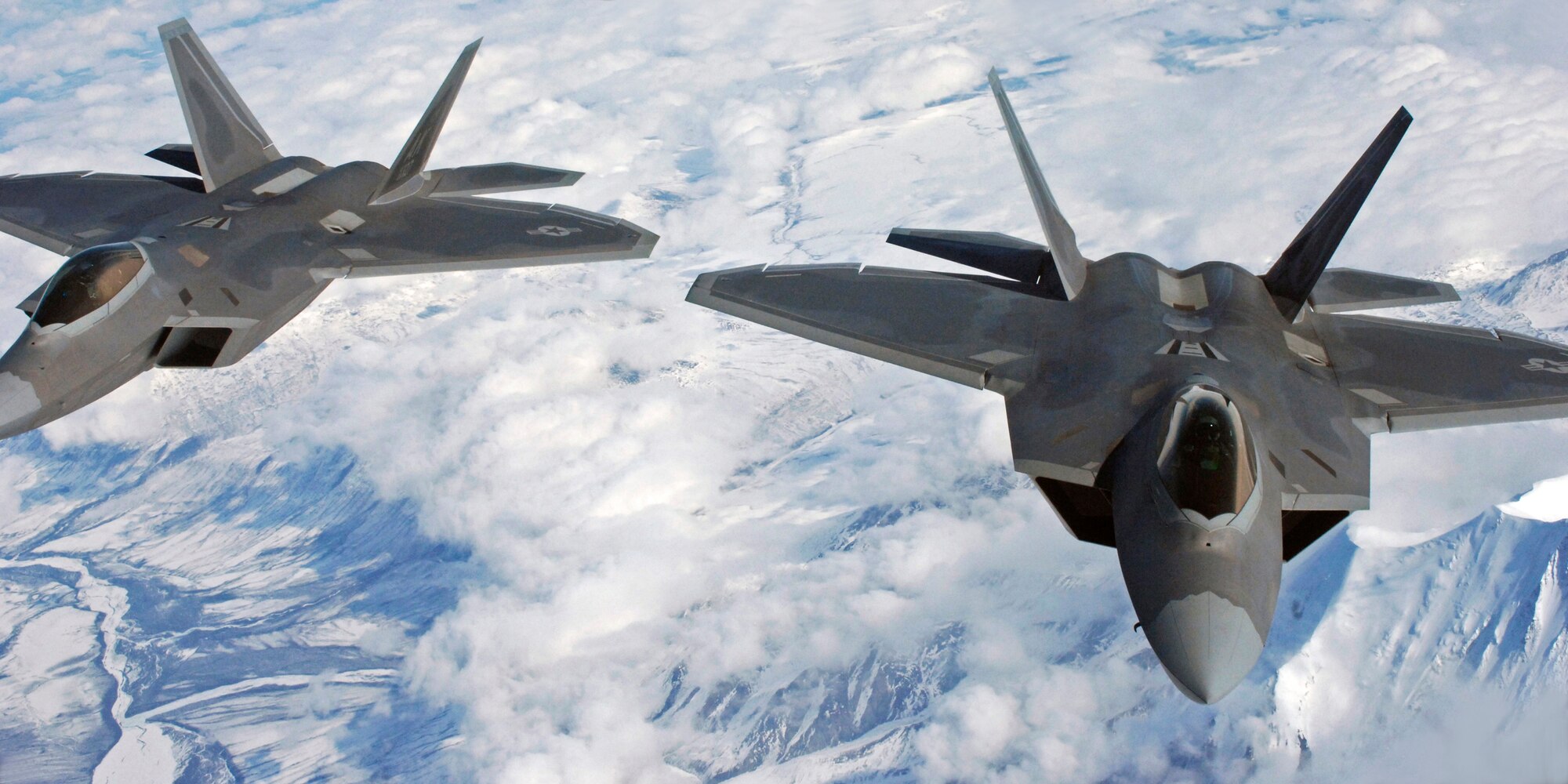 ELMENDORF AFB, Alaska -- Two F-22 Raptors fly wing to wing during an in-flight refueling mission on April 15, 2009. Both fighters were refuled by the KC-135 and returned home to Elmendorf (U.S. Air Force photo by Senior Airman Laura Turner) (RELEASED)