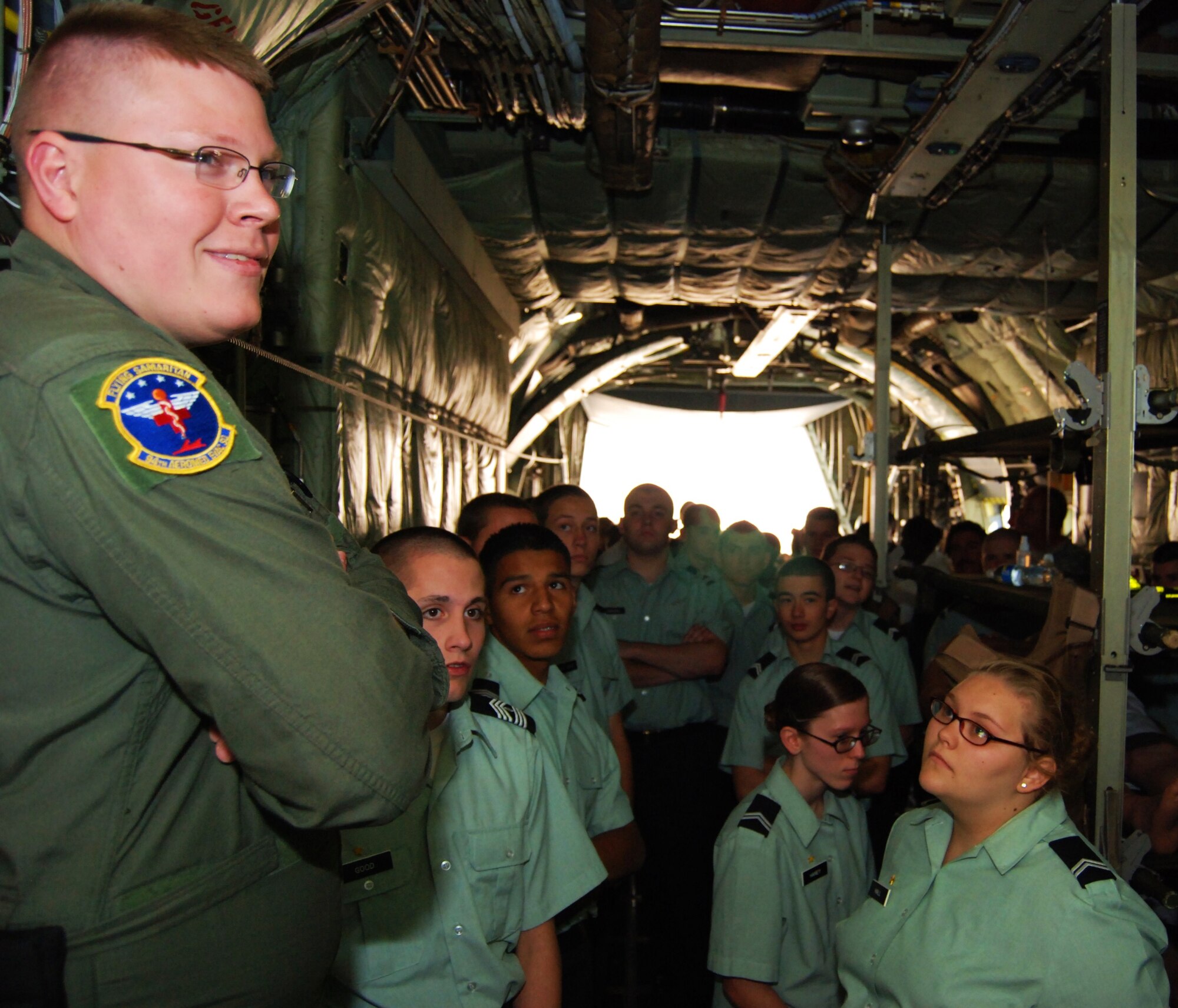 Staff Sgt.Joshua Albertin, 94th Aeromedical Evacuation Squadron, presents a demonstration of how the military evacuates injured personnel to Adairsville High School Army JROTC cadets April 15. More than 1,000 cadets flew aboard a C-130 aircraft and toured static displays inside a hangar to learn more about U.S. Air Force careers April 14-15.(U.S. Air Force photo/Airman Chelsea Gitzen)