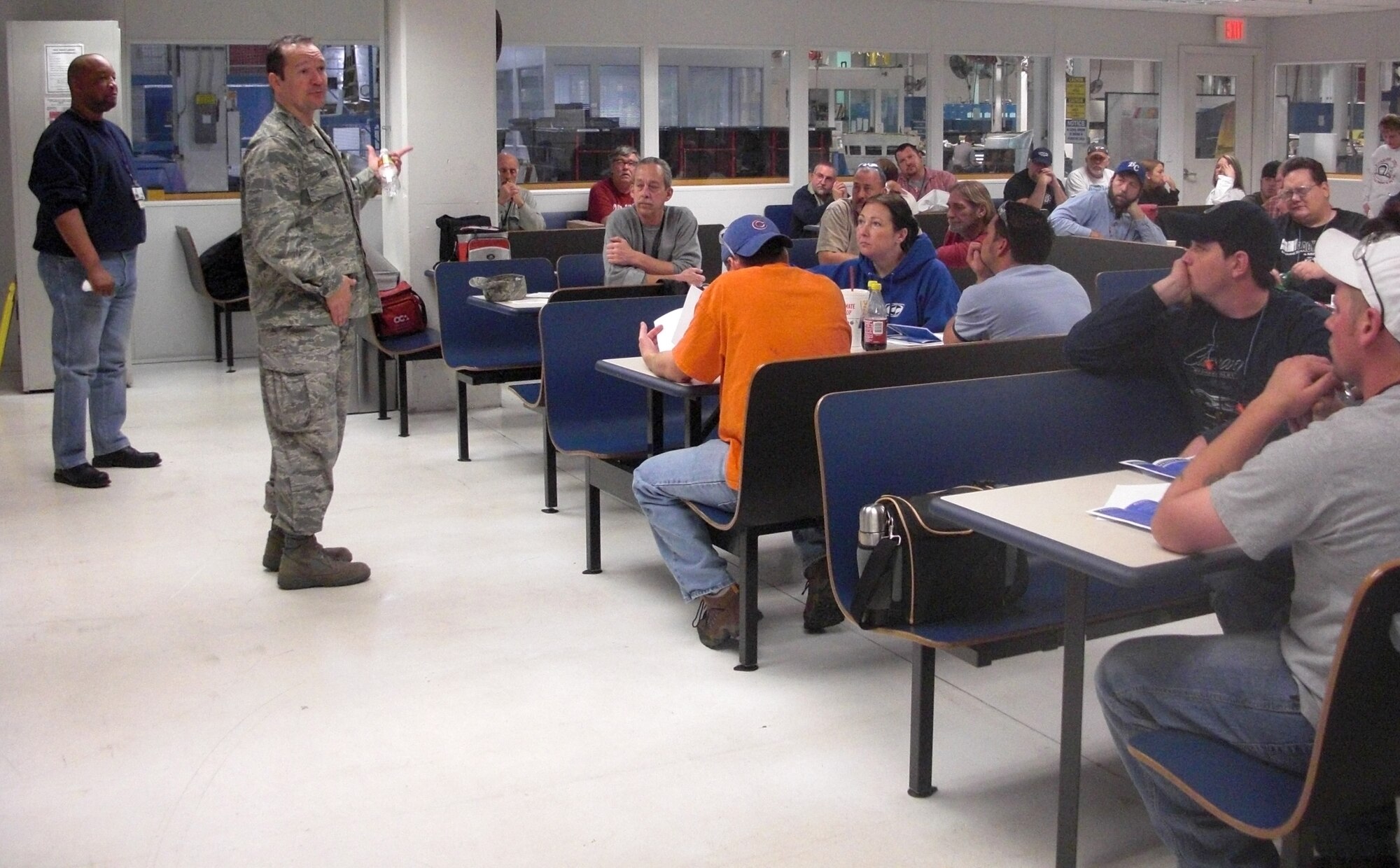 Col. Jeffrey Sick, 76th Commodities Maintenance Group commander, holds a town hall meeting with workers in a common area. The meetings are meant to smooth the transition to the new Tinker Aerospace Complex by informing the work force.(Air Force photo/Christy Jaworsky) 