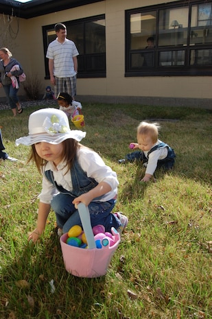 Joscalyne, 3, and her brother, Bron, 1, find Easter eggs outside the base chapel April 11. More than 30 children searched the chapel grounds for more than 500 plastic eggs filled with candies and Bible verses. The Easter egg hunt is an annual event hosted by the 341st Missile Wing chapel staff. (U.S. Air Force photo/Staff Sgt. Eydie Sakura)