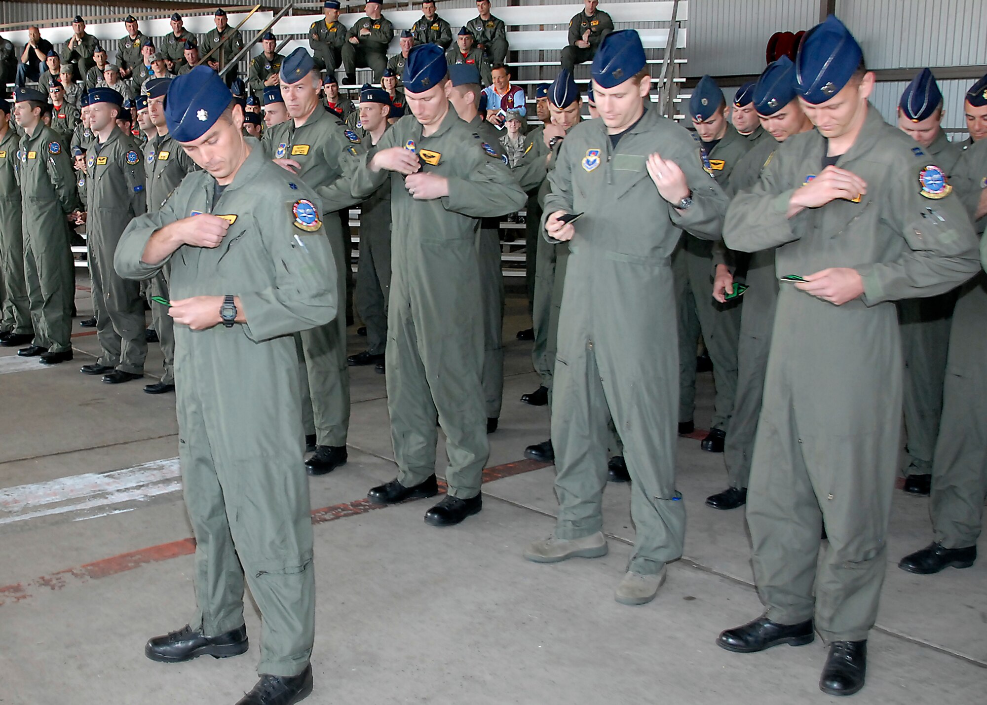 Members of the 90th Flying Training Squadron officially transferred to the 469th FTS when they removed their old squadron patch on their uniforms and replaced it with the 469th FTS patch at the 469th FTS reactivation ceremony April 10. The new squadron was reactivated to alleviate congestion in the 90th FTS.(U.S. Air Force photo/Mike Litteken)