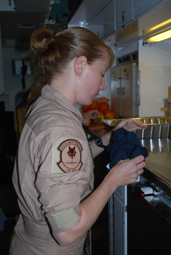 Tech. Sgt. Jennifer Lindner, 89th Airlift Wing, Operations Support Squadron, Andrews AFB, M.D., cooks up a dinner fit for a king, president, general or anyone else who might be on the aircraft. (Air Force photo/Major Bill Walsh)