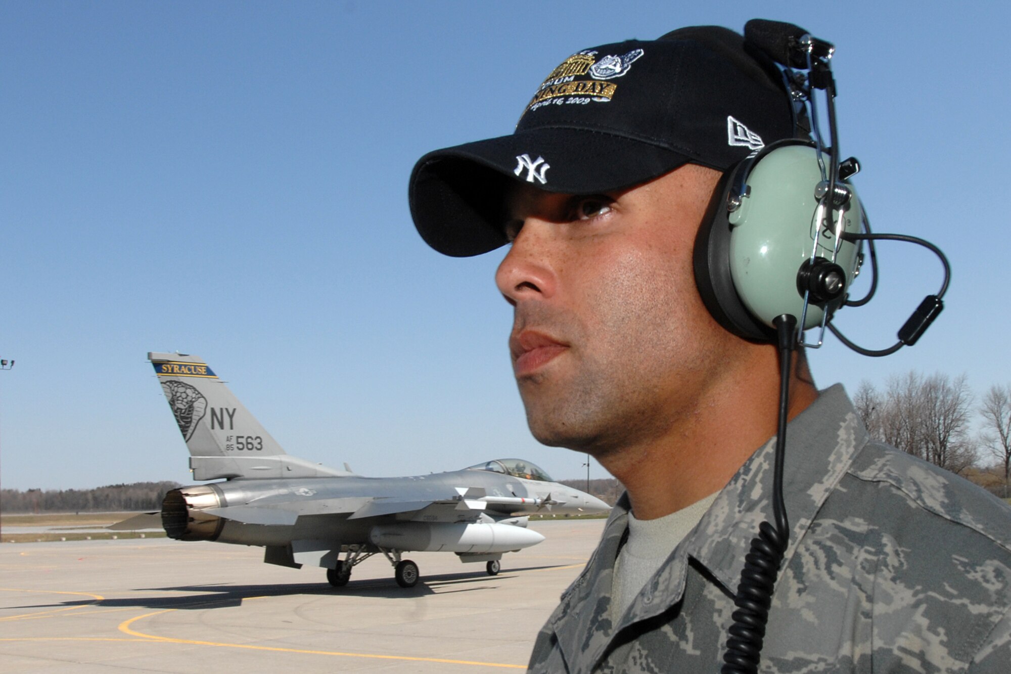 The 174th Fighter Wing, Syracuse NY, F-16C Fighting Falcon depart Hancock Field Air National Guard Base to take part in the 2009 "New" Yankee Stadium Opening Day Ceremonies. Staff Sgt. Preston Cox, 174 Fighter Wing Crew Chief watches the jets taxi out for their mission. (USAF Photo by: SSgt James N. Faso II)