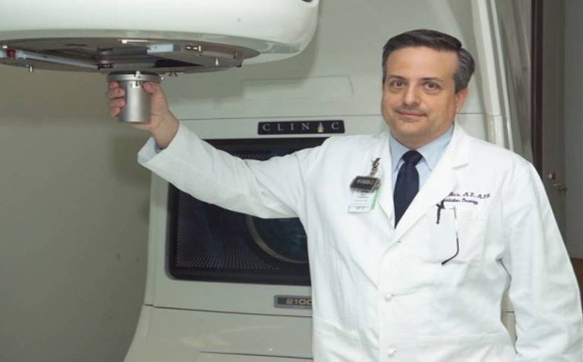 Dr. (Lt. Col.) Ronald Hale, Chief of Radiation Oncology, demonstrates the device used to focus the stereotactic radiosurgery beam to within 2-5 millimeters of center target.