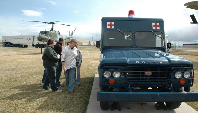 Malmstrom Museum visitors look at the newly painted 1963 Dodge Power-Wagon response ambulance April 13 at the Air Park. The 341st Logistics Readiness Squadron allied trades shop staff placed it back on display April 10 after repainting it. (U.S. Air Force photo/Senior Airman Dillon White)