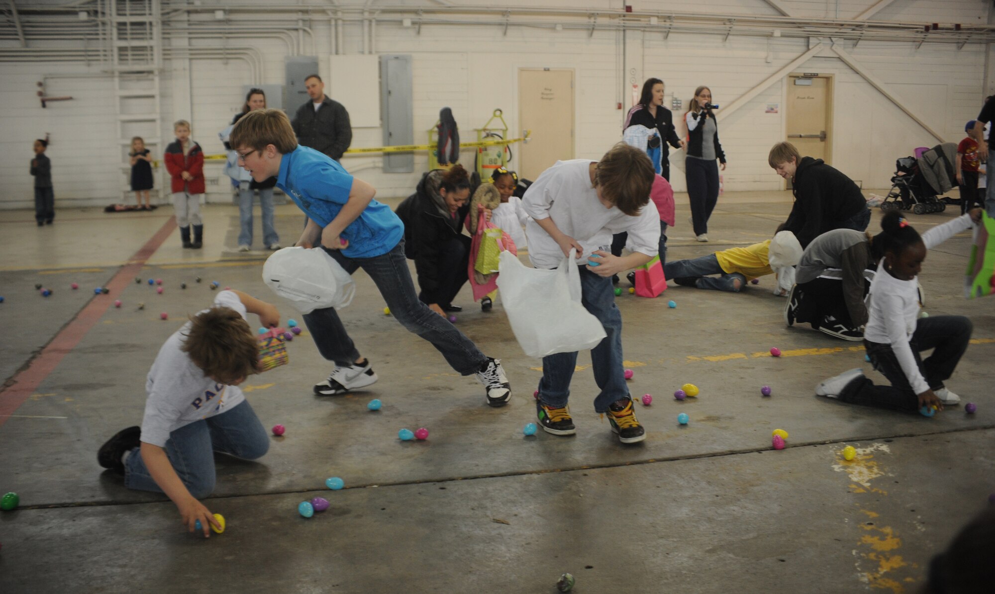 ELMENDORF AIR FORCE BASE, Alaska-- Children disperse in a wild frenzy for Easter eggs during Elmendorf's annual EGGstavaganza on April 11, 2009. The eggs contained various items from assorted candies to gift tags redeemable for everything from Elmo play sets to mountain bikes. (U.S. Air Force photo by Airman First Class Kristin High)